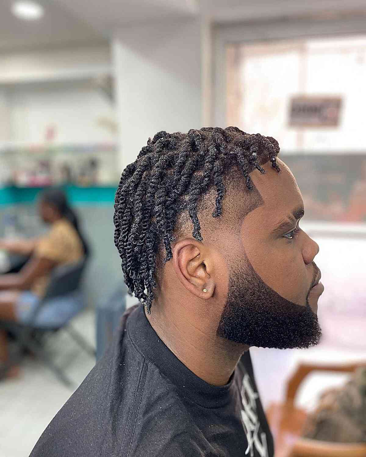Short twists on top with faded sides and a shaped beard.