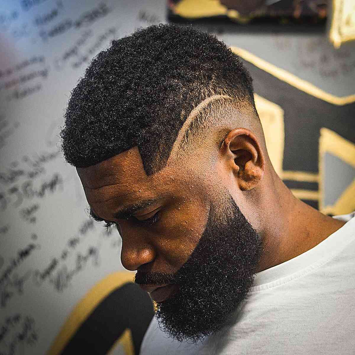 Short top with a faded side and a beard connected by a sharp line.