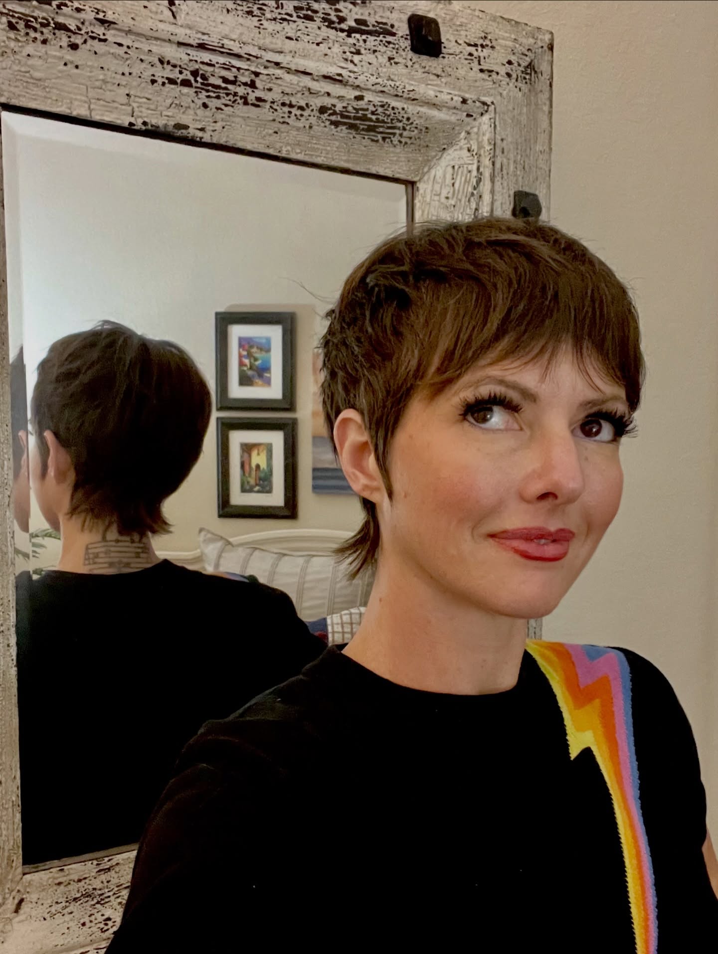 Textured dark pixie with micro fringe and a pointed nape tail.
