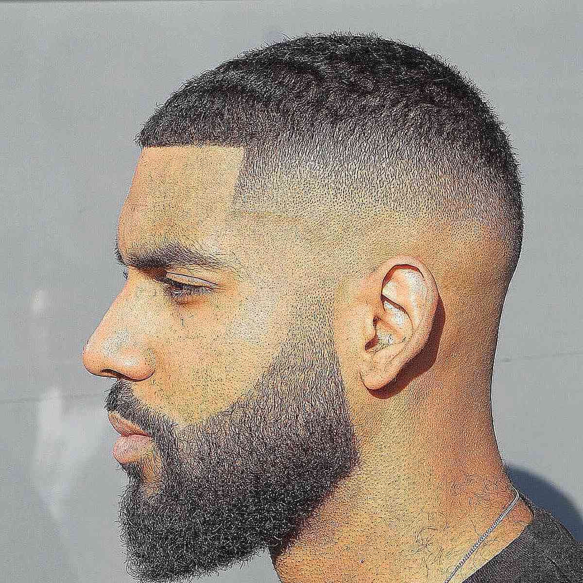 Very short Caesar-style cut with a sharp line and fade.