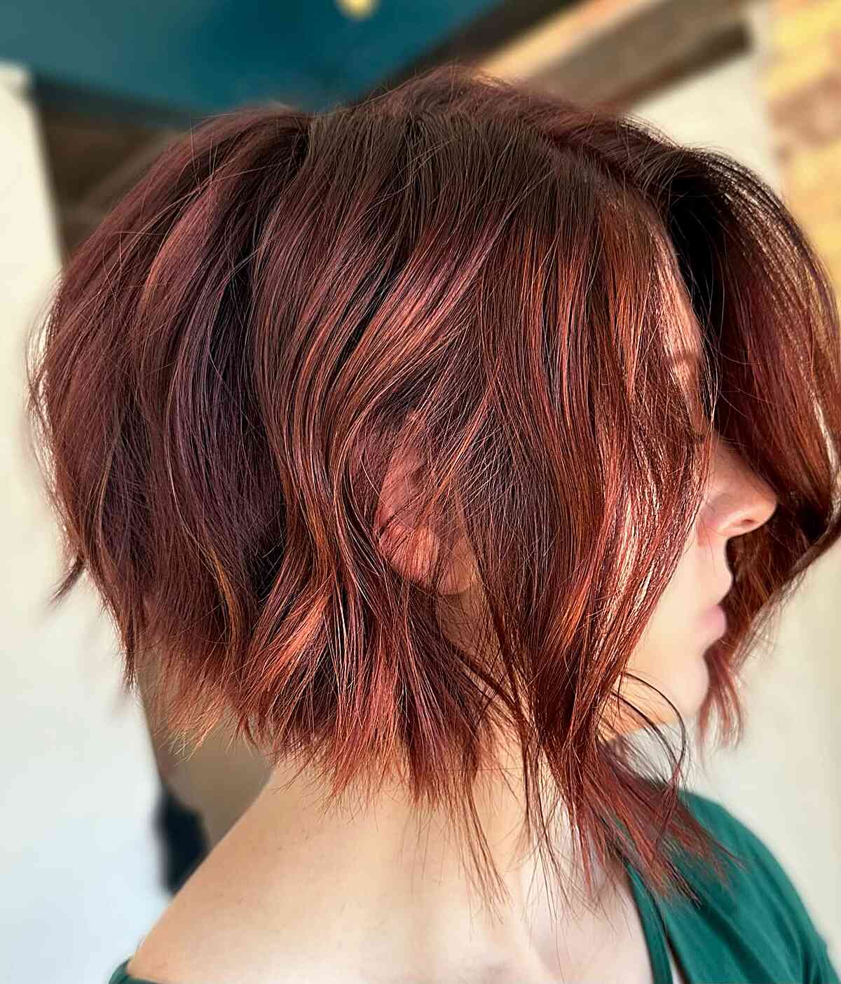 Crimson angled bob with textured layers and longer front pieces.