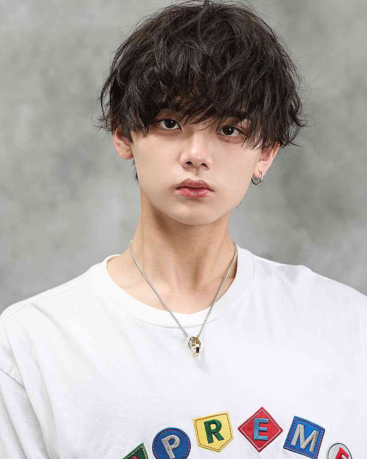 Messy layered cut with long textured fringe and soft volume.
