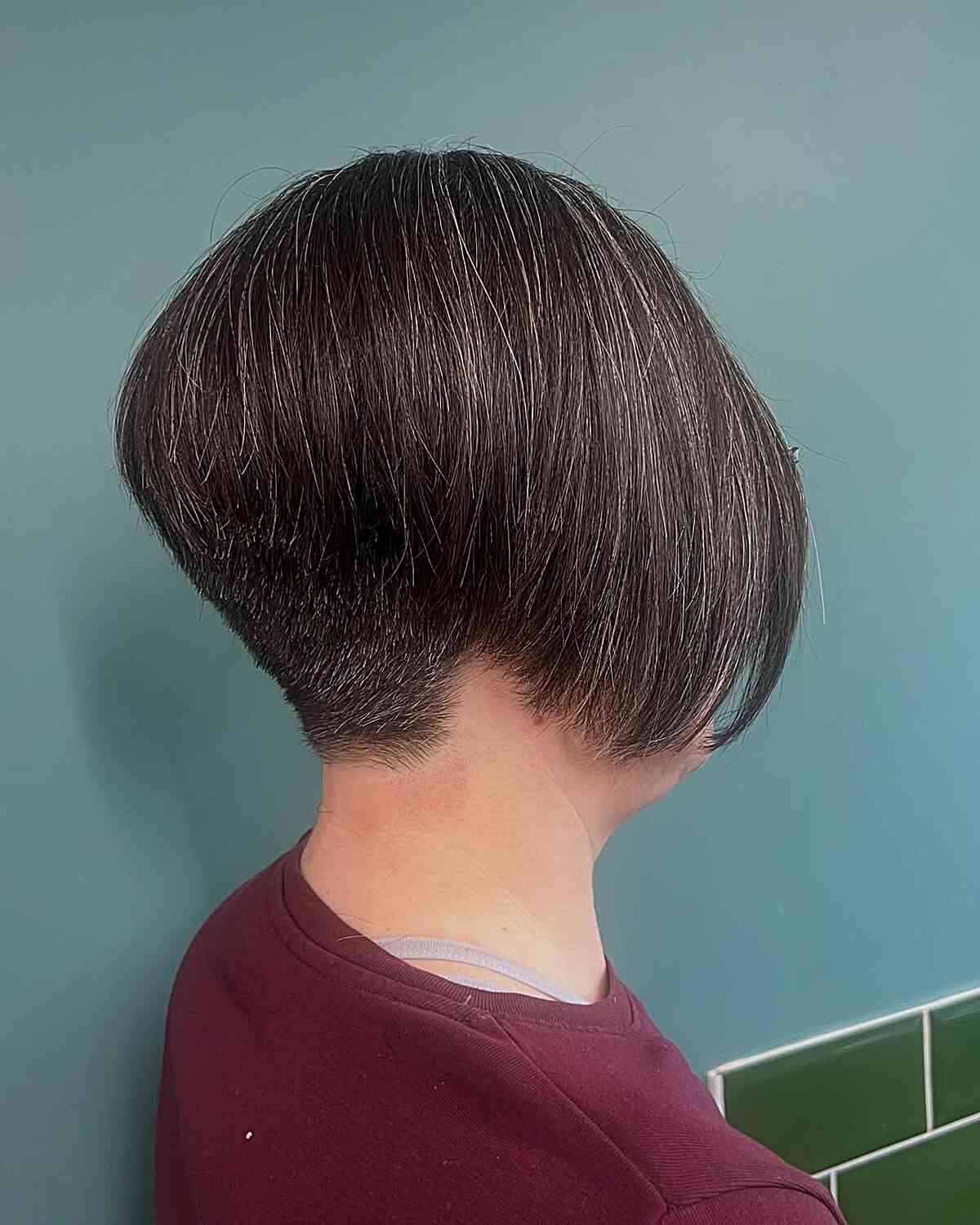 Rounded pixie bob with a tapered nape and smooth side sweep.