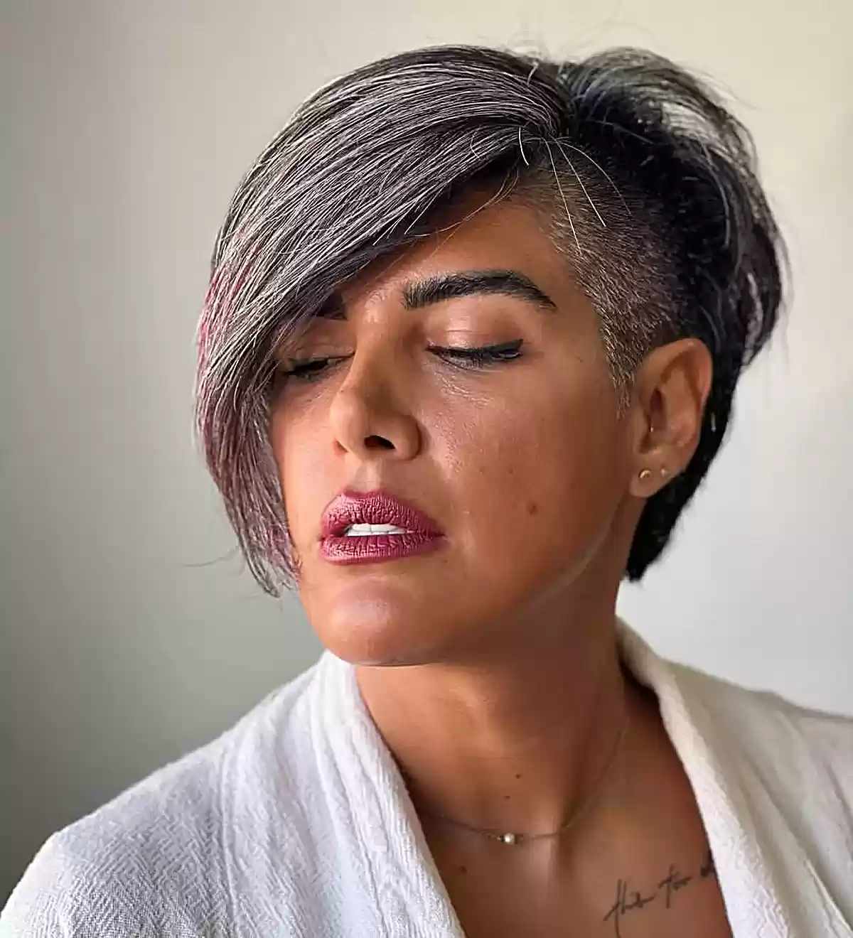 Pixie with shaved side and long swept fringe