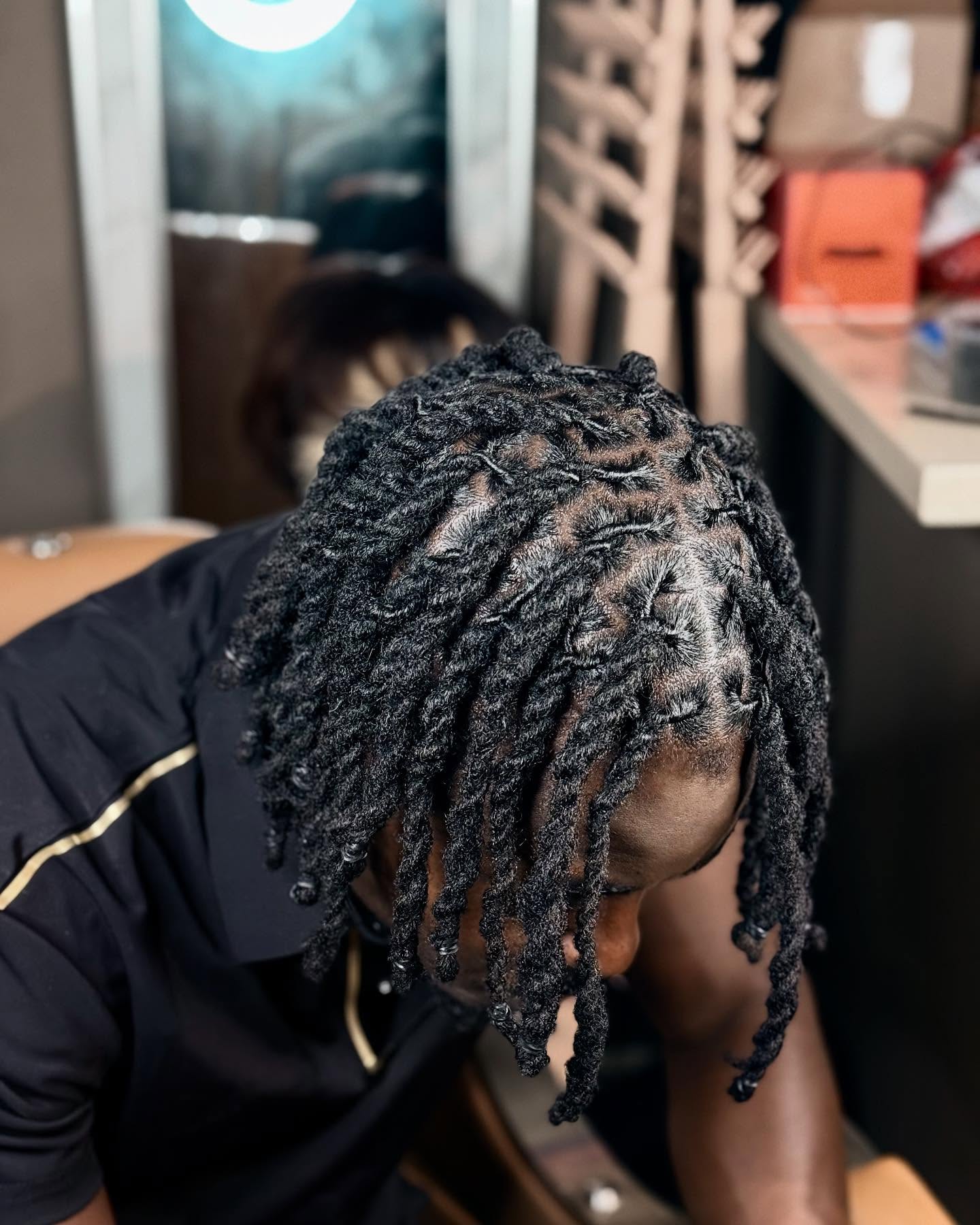 Loose dread twists with a low fade and forward movement.