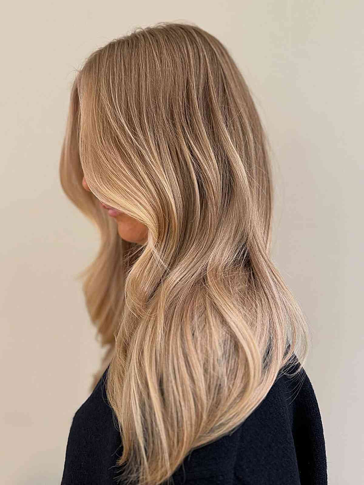 Soft beige blonde waves with smooth, long layers.