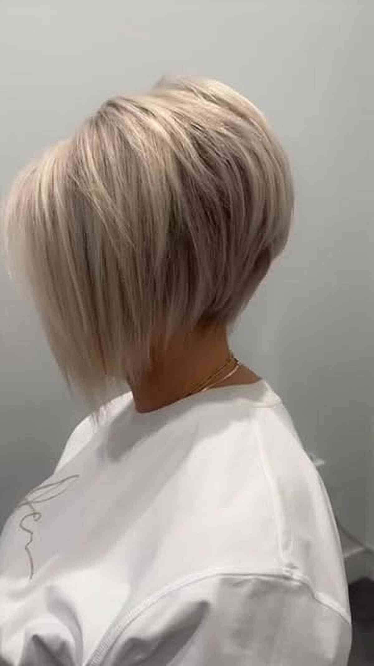 Blonde angled bob with textured layers and a light finish.