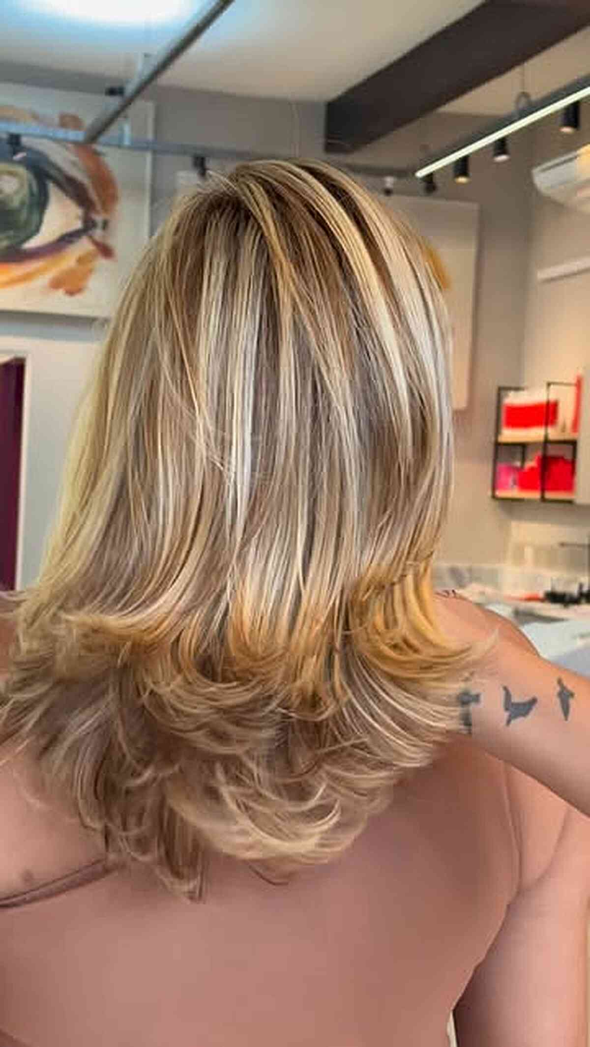 Creamy beige blonde layers with a soft shadow root.