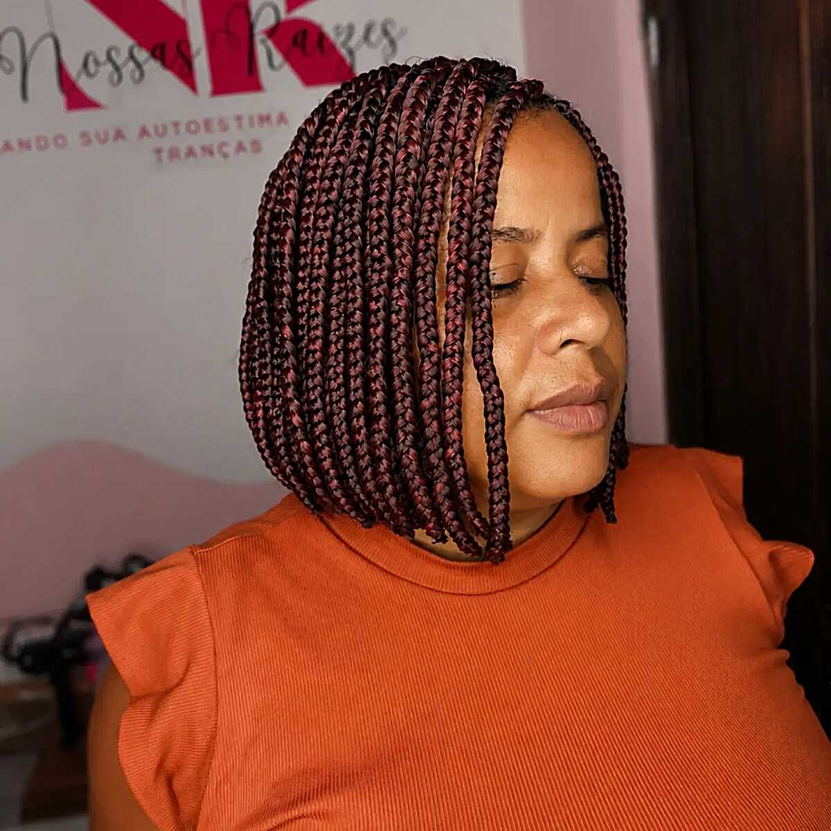 Short burgundy box braid bob with a blunt edge
