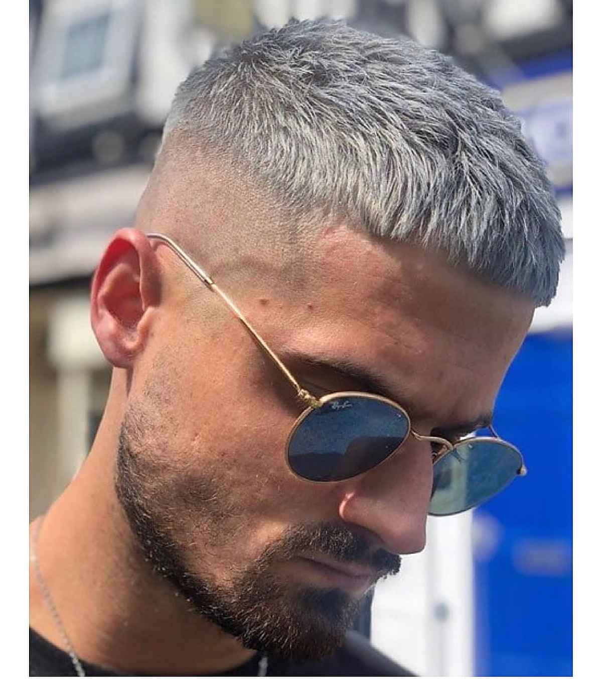 Silver cropped fringe with a tight fade and short top.