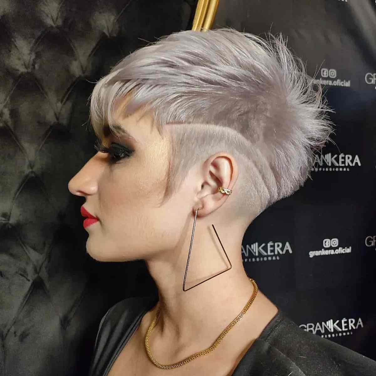 Disconnected pale blonde pixie with shaved underlayer and longer top.