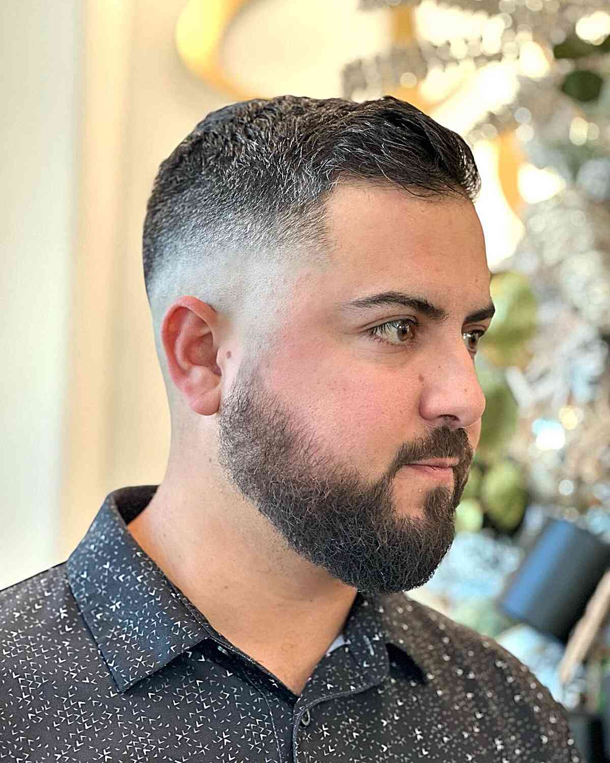 Short crew cut with a mid drop fade and subtle forward texture.