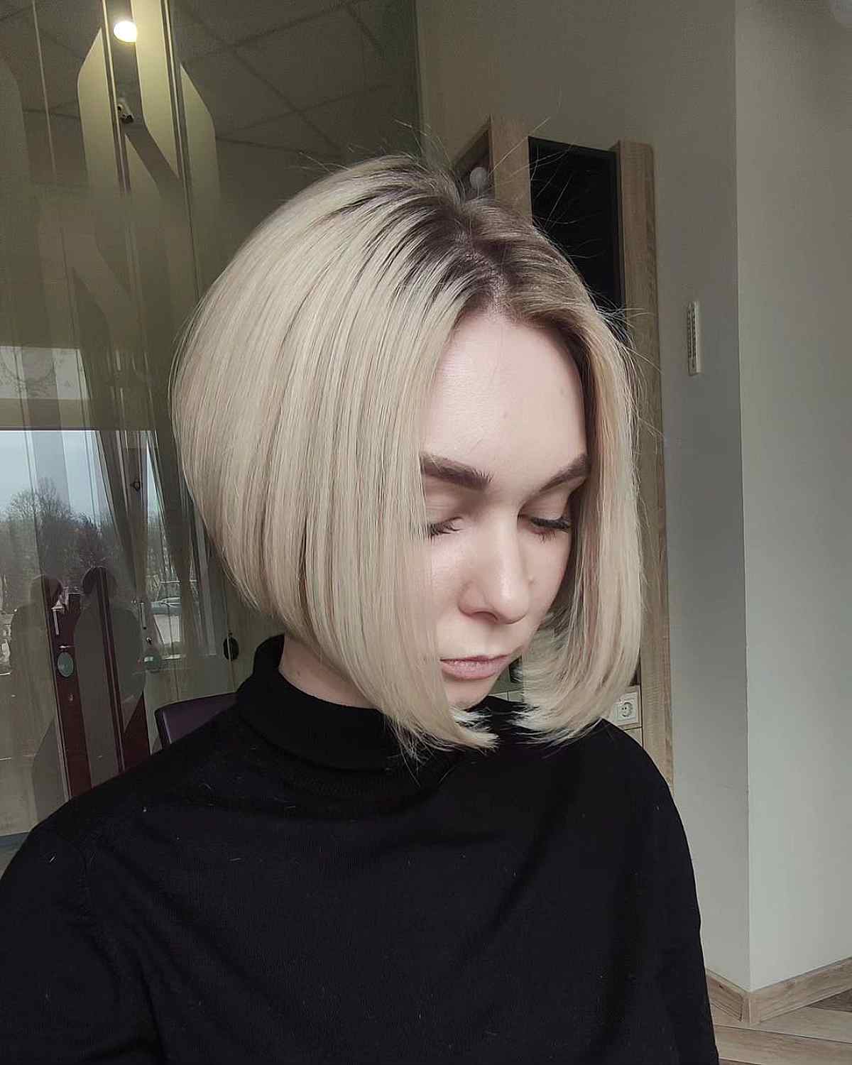 Platinum angled bob with smooth sides and a lifted crown.