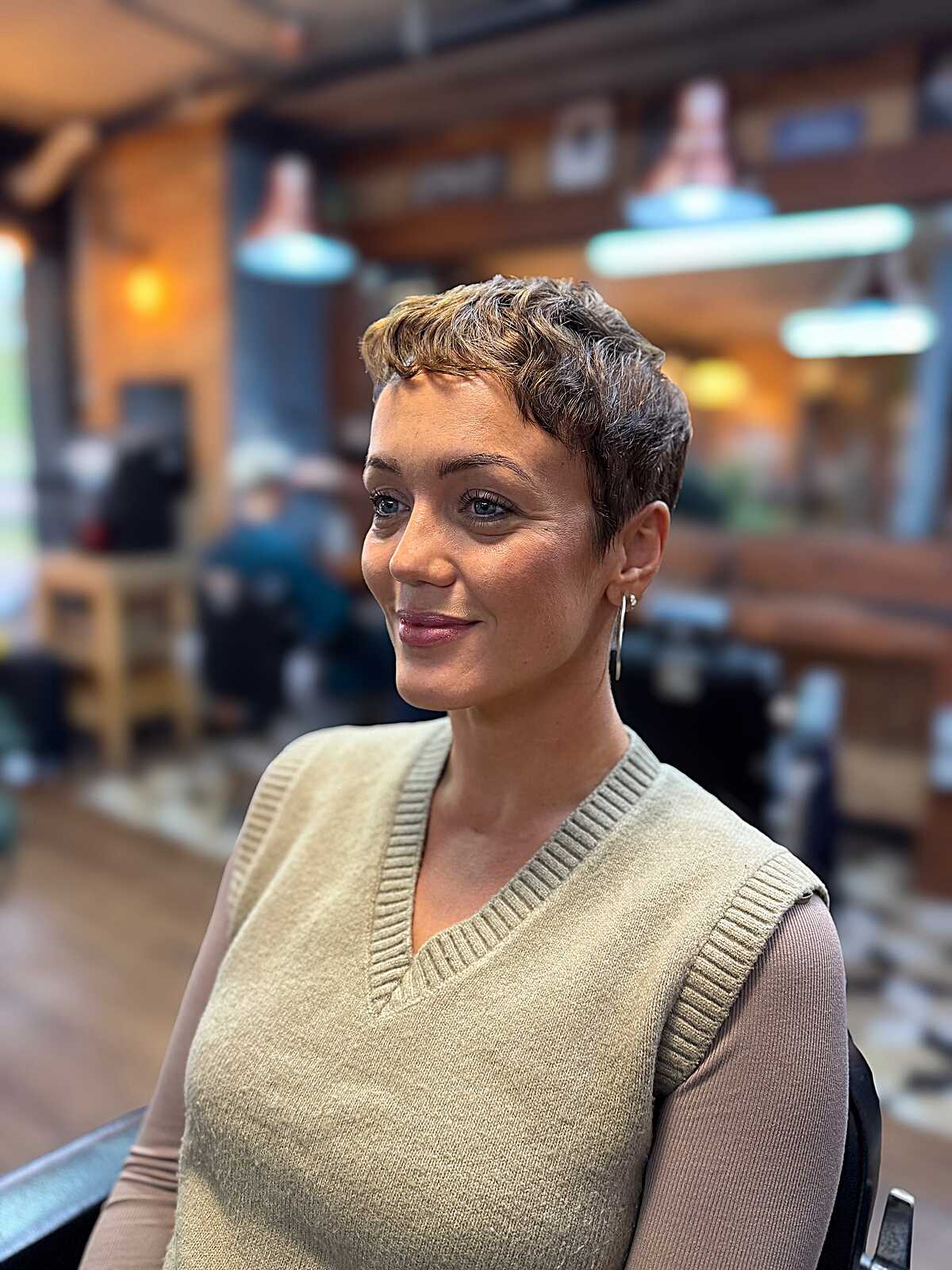 Pixie with honey-toned crown waves and close sides.