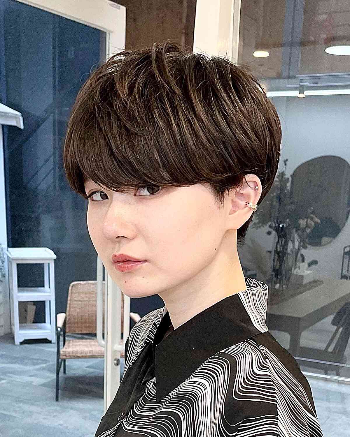 Short dark crop with full bangs and rounded sides
