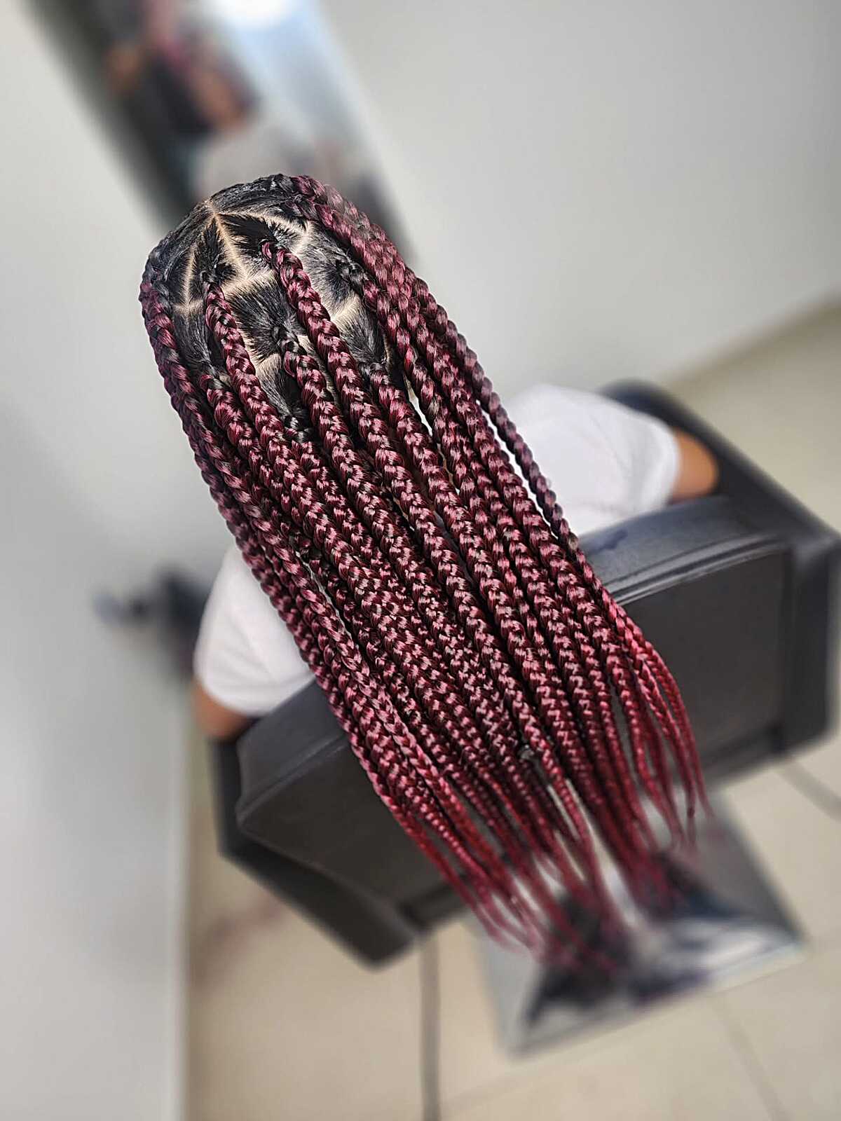 Long burgundy box braids with triangle parting