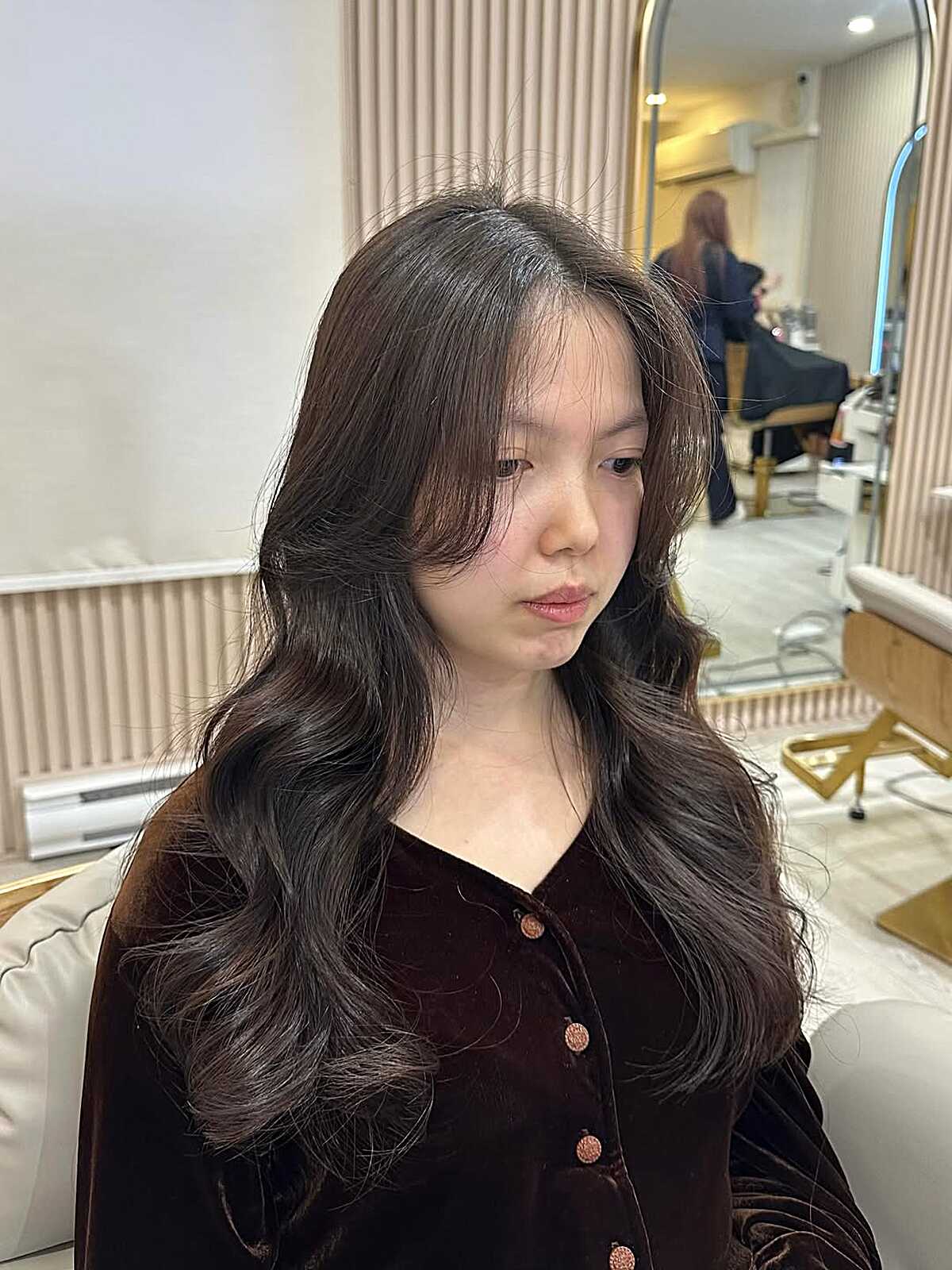 Long dark brown waves with center part and curtain layers.
