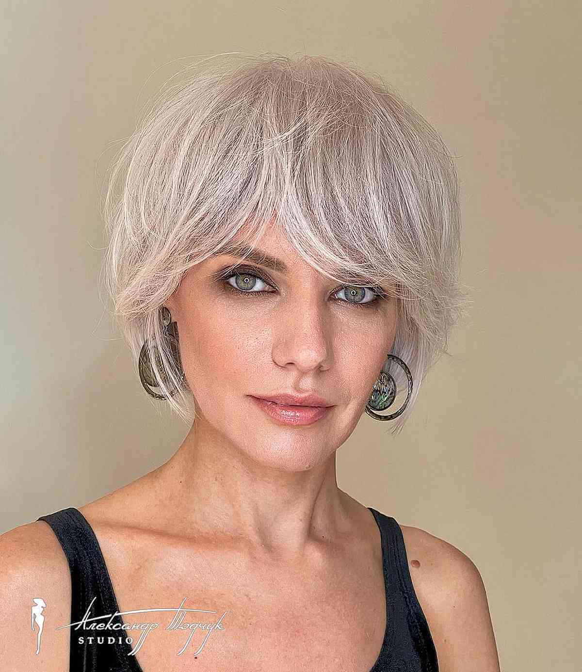 Soft platinum shag crop with loose layers and fringe.