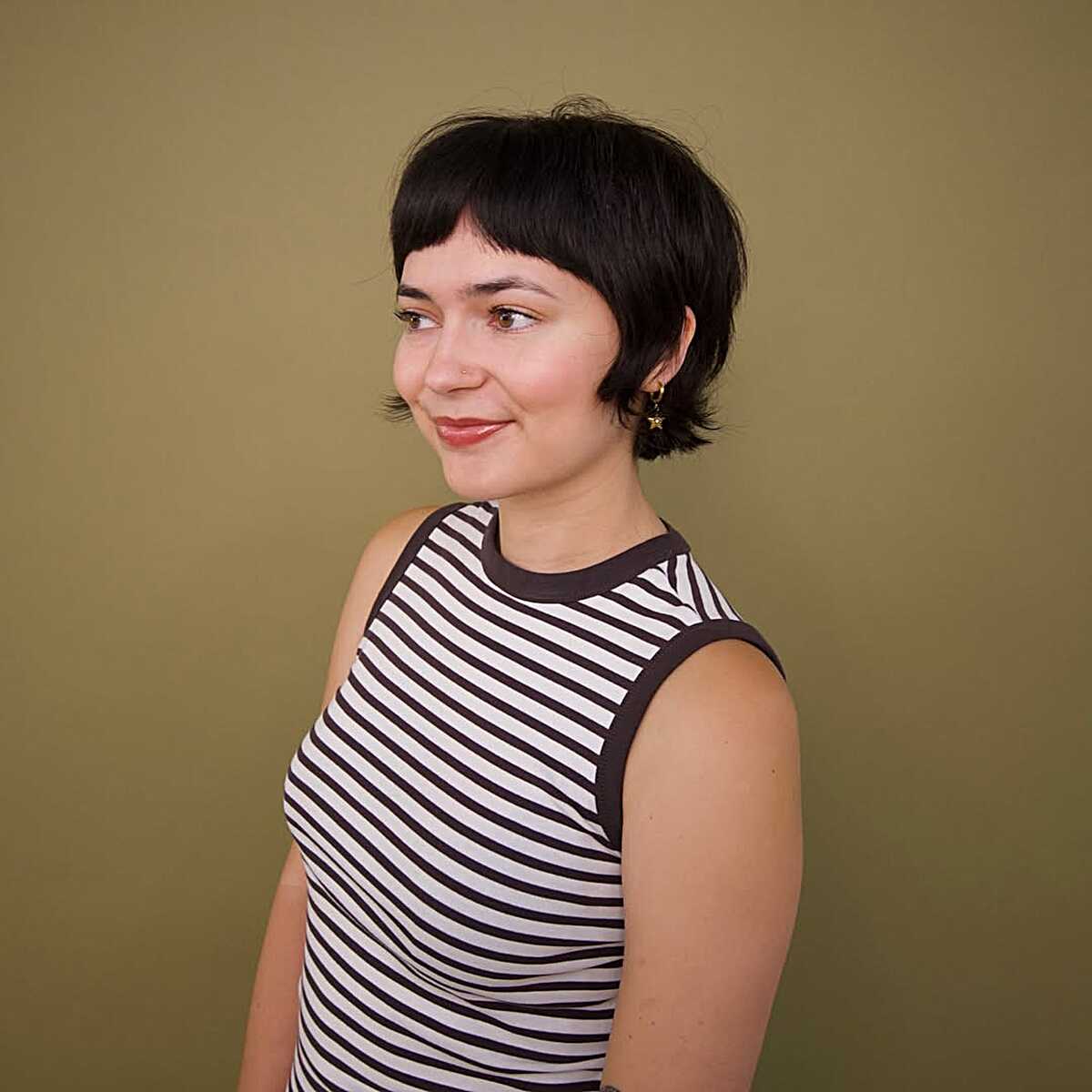 Short black bob with heavy straight bangs and close-cropped sides