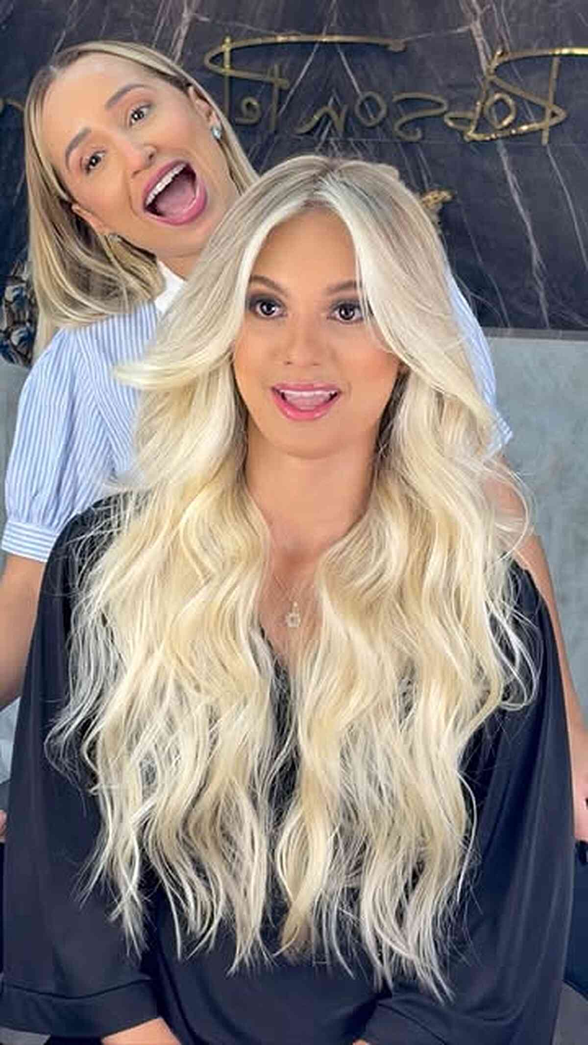 Extra-long platinum wavy hair with center part and face-framing pieces.