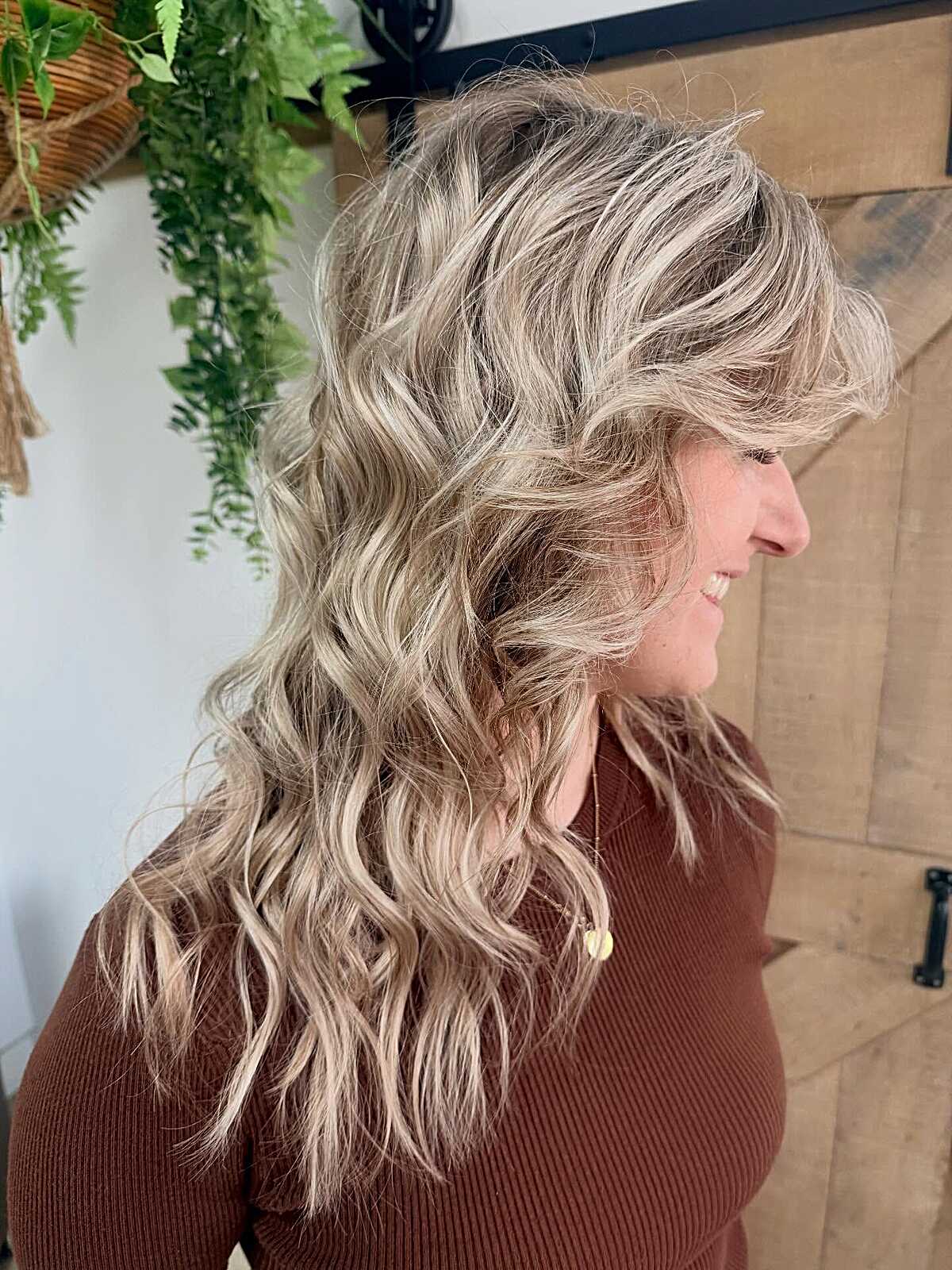 Platinum blonde wavy hair with voluminous choppy layers.