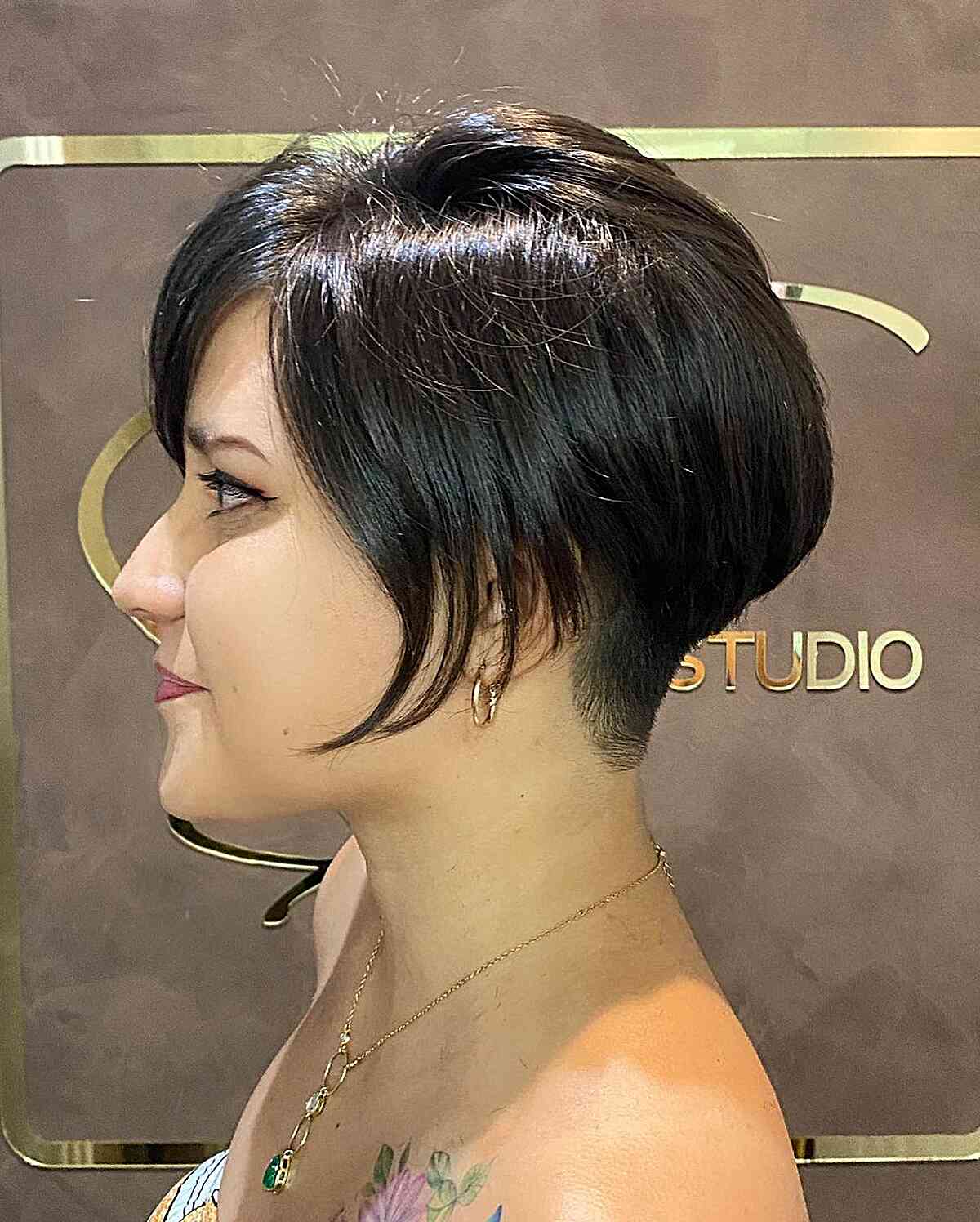 Dark pixie bob with side fringe and a close nape.