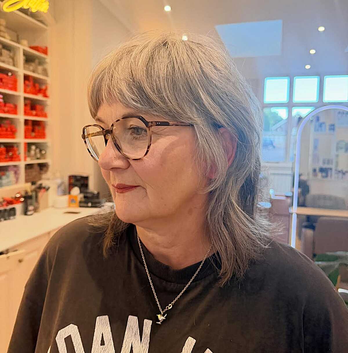 Silver shag with feathered bangs and layered, wispy ends.