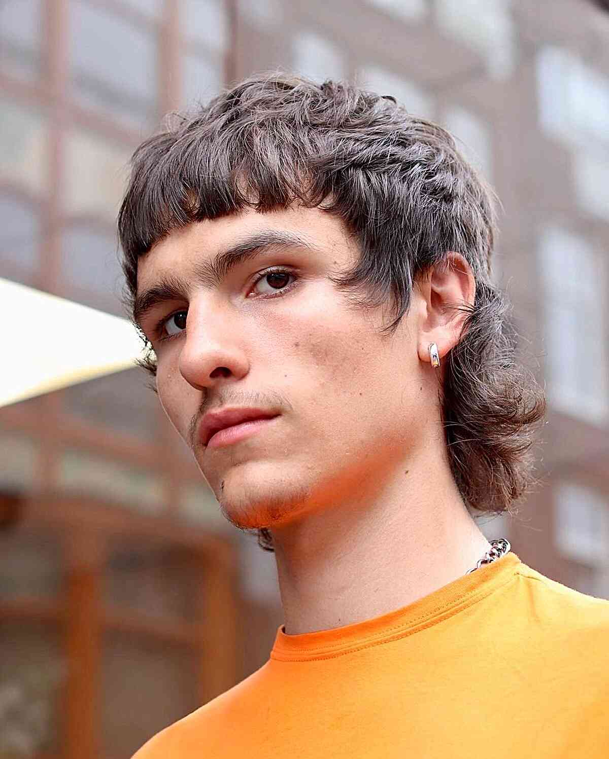 Layered mullet with short fringe, short sides, and longer back.
