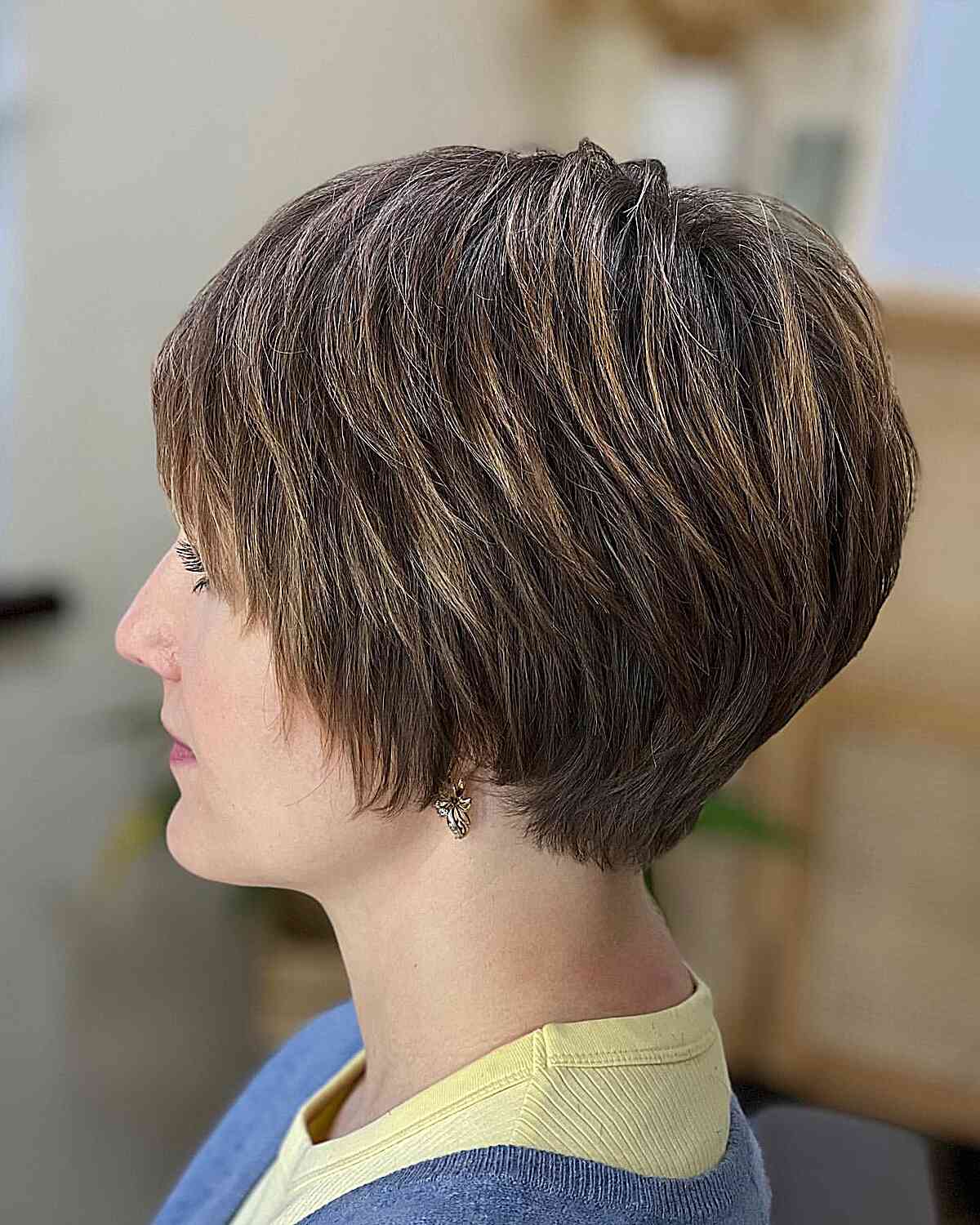 Angled short bob with wispy layers and a tapered nape
