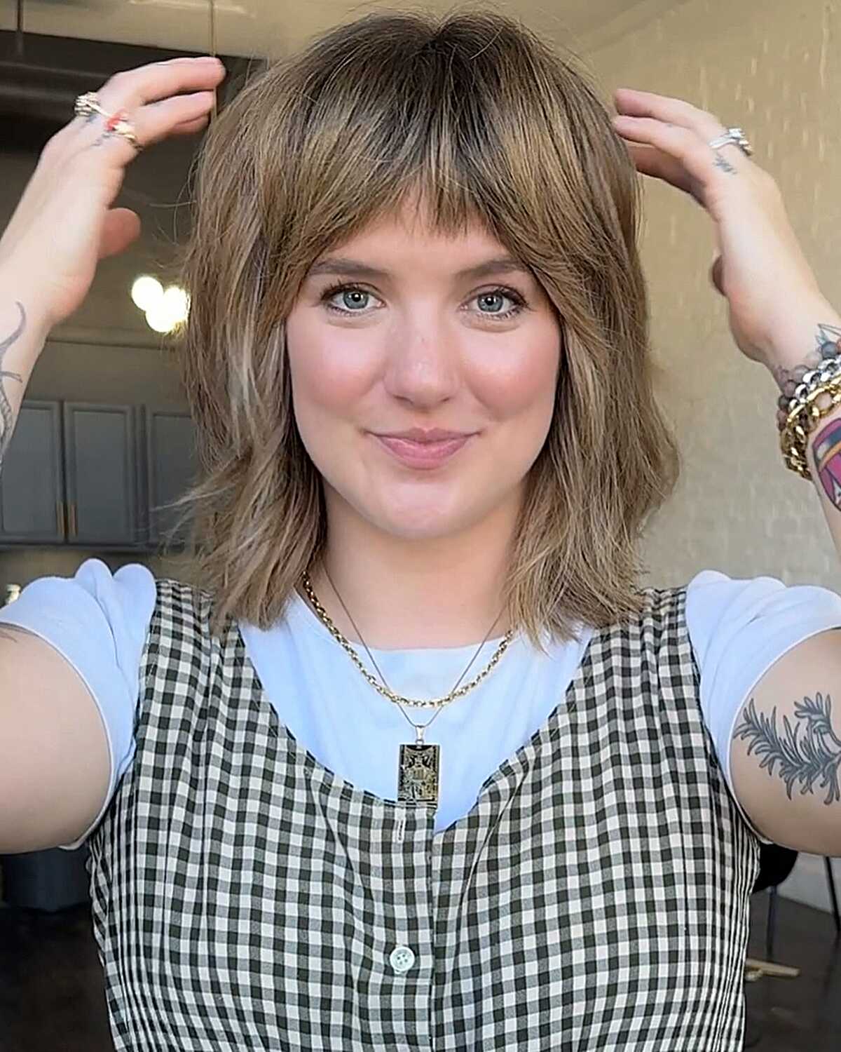 Chin-length choppy shag with full bangs and outward ends.