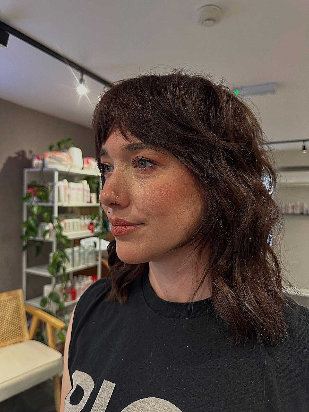 Chocolate brown wavy shag with soft fringe and layered ends.