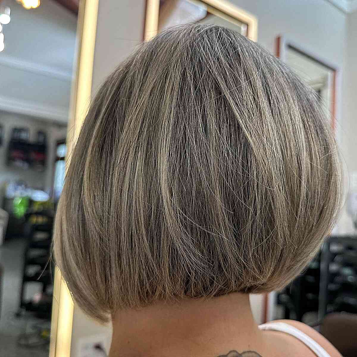 Straight rounded bob with subtle lowlights and tucked ends.