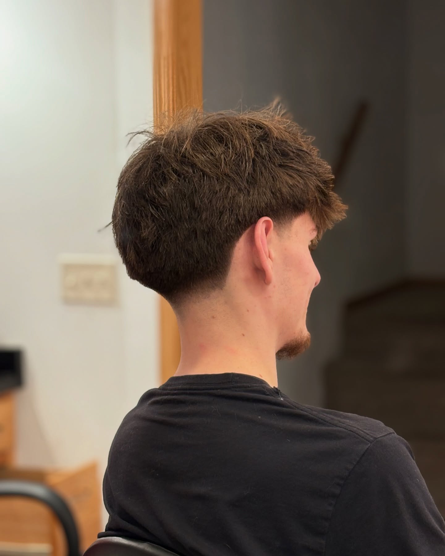 Textured longer top with clean tapered back and sides.