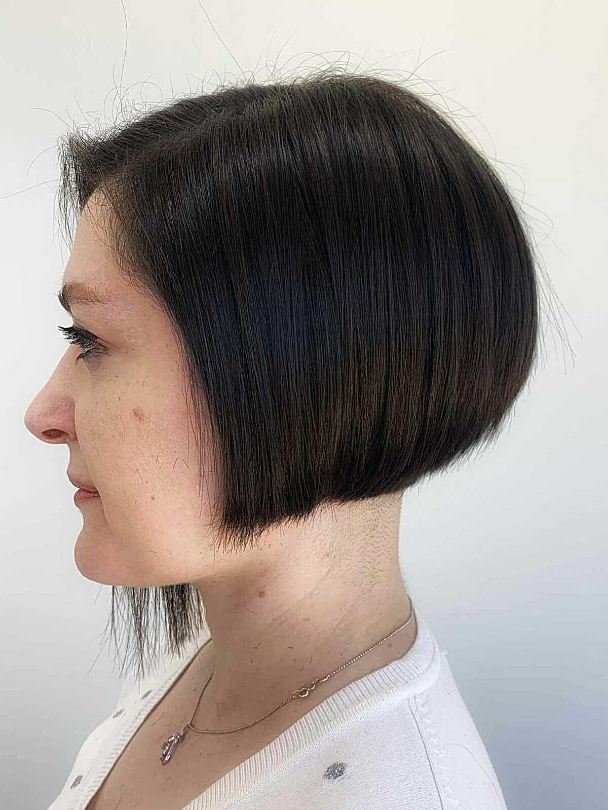 Dark brunette angled bob with micro bangs and a neat outline.