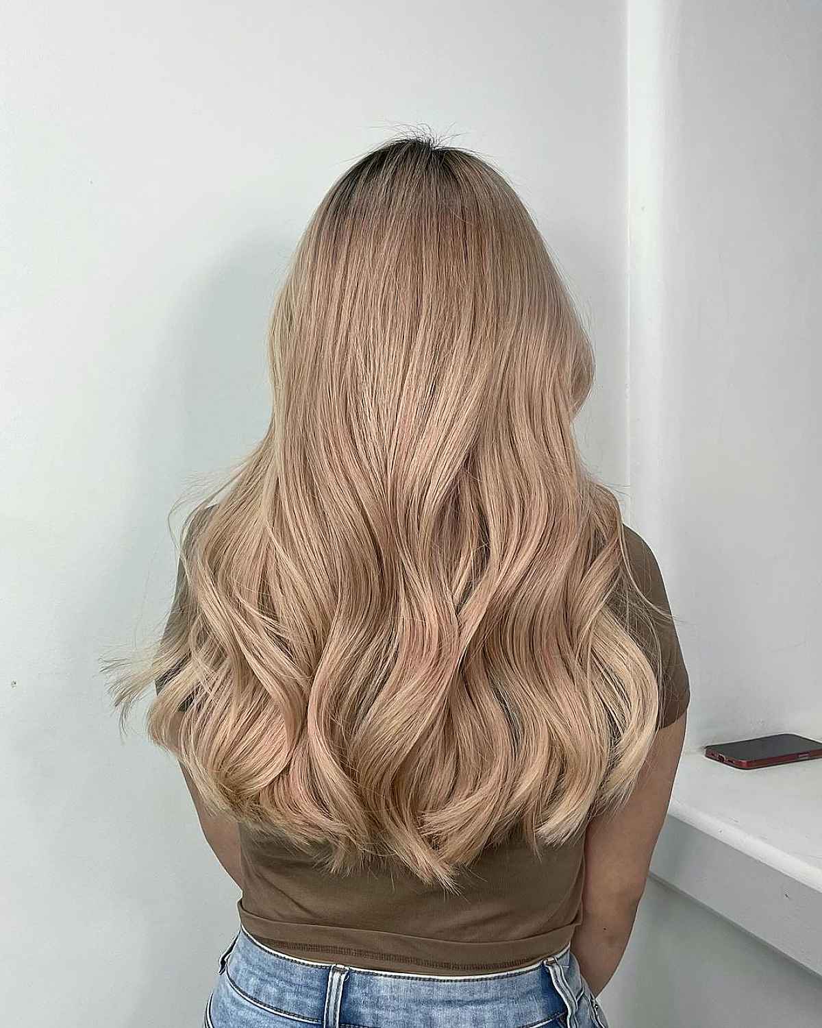 Champagne beige blonde long waves with a center part.