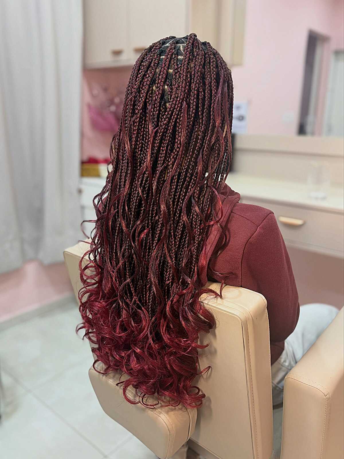 Long burgundy box braids with softly curled tips