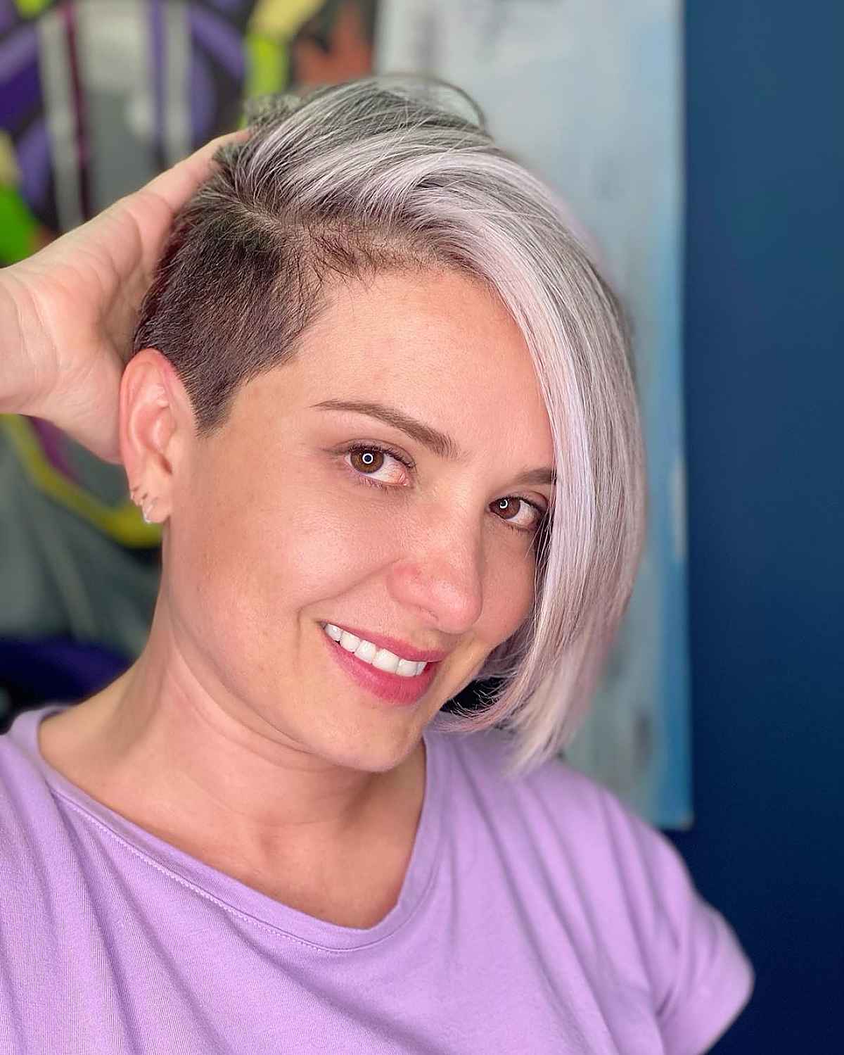 Hidden undercut pixie bob with a long front panel and silver blonde tone.