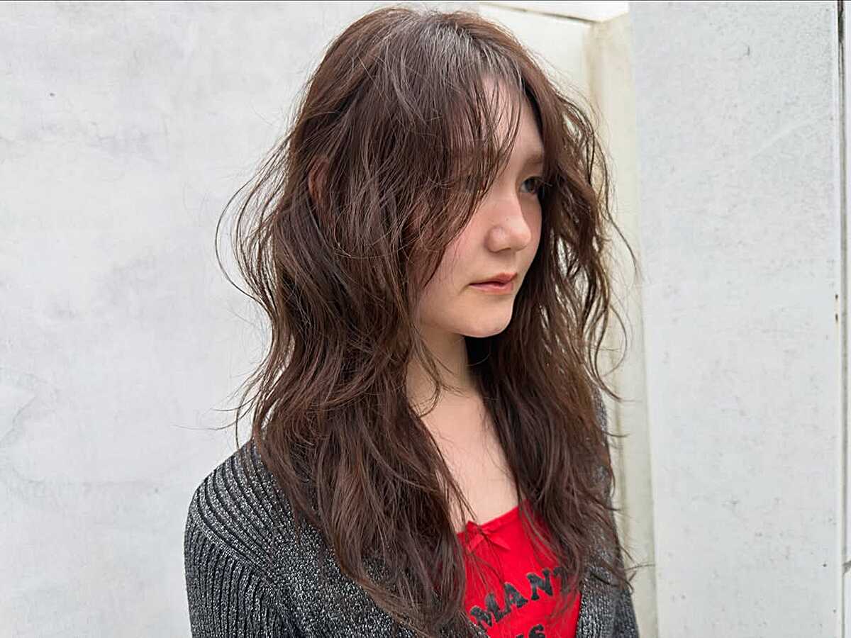 Medium layered brown wavy hair with warm undertones.