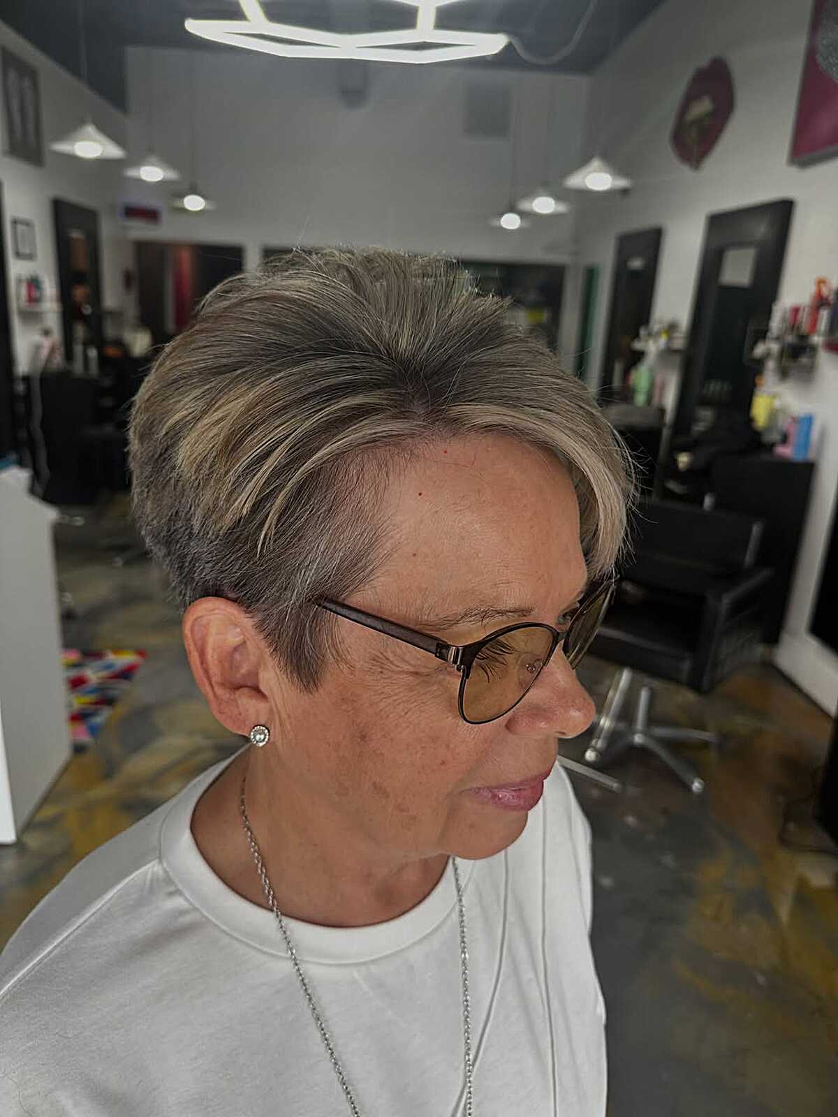 Ash blonde pixie with swept fringe and clean sides.