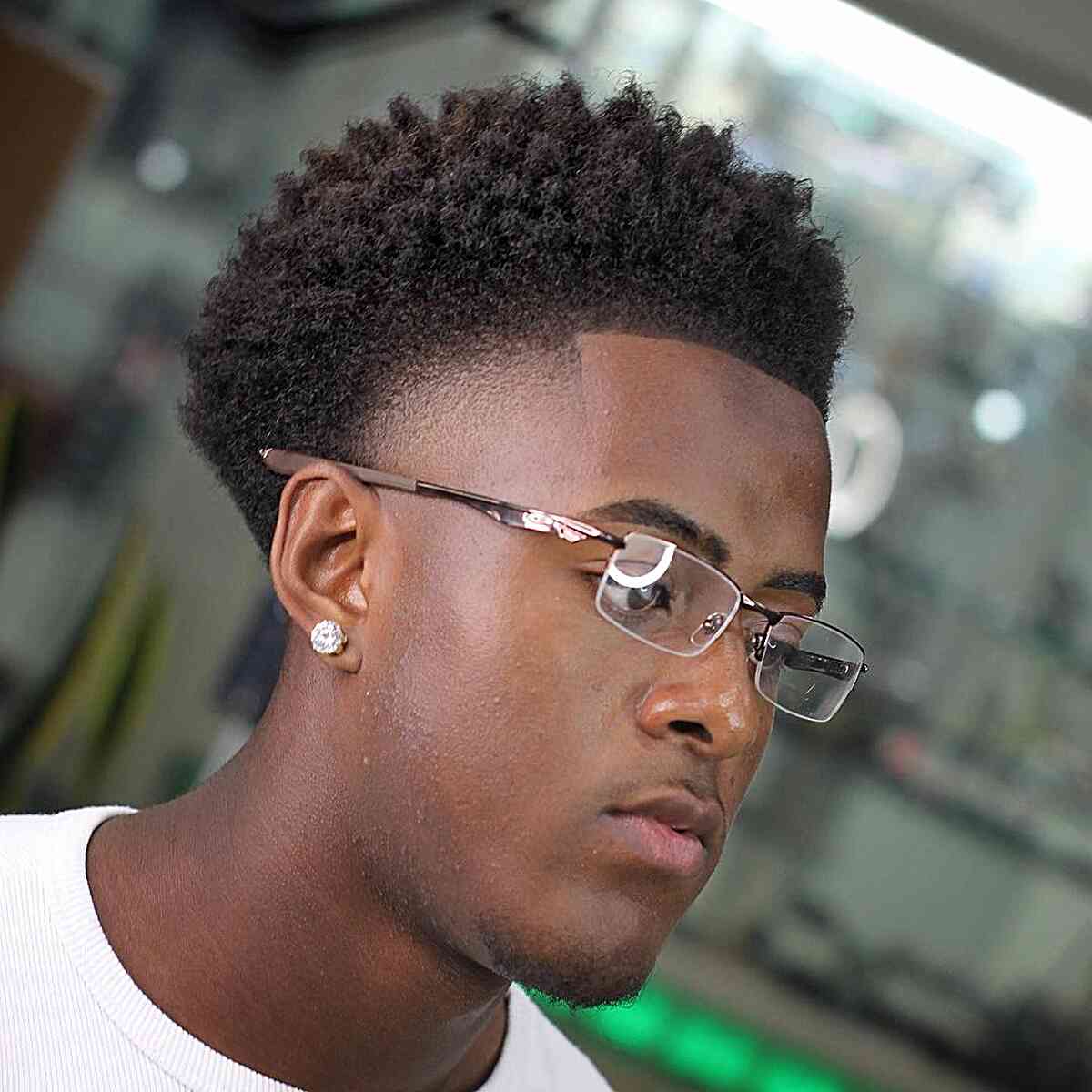 Short textured top with low fade and sharp squared hairline.