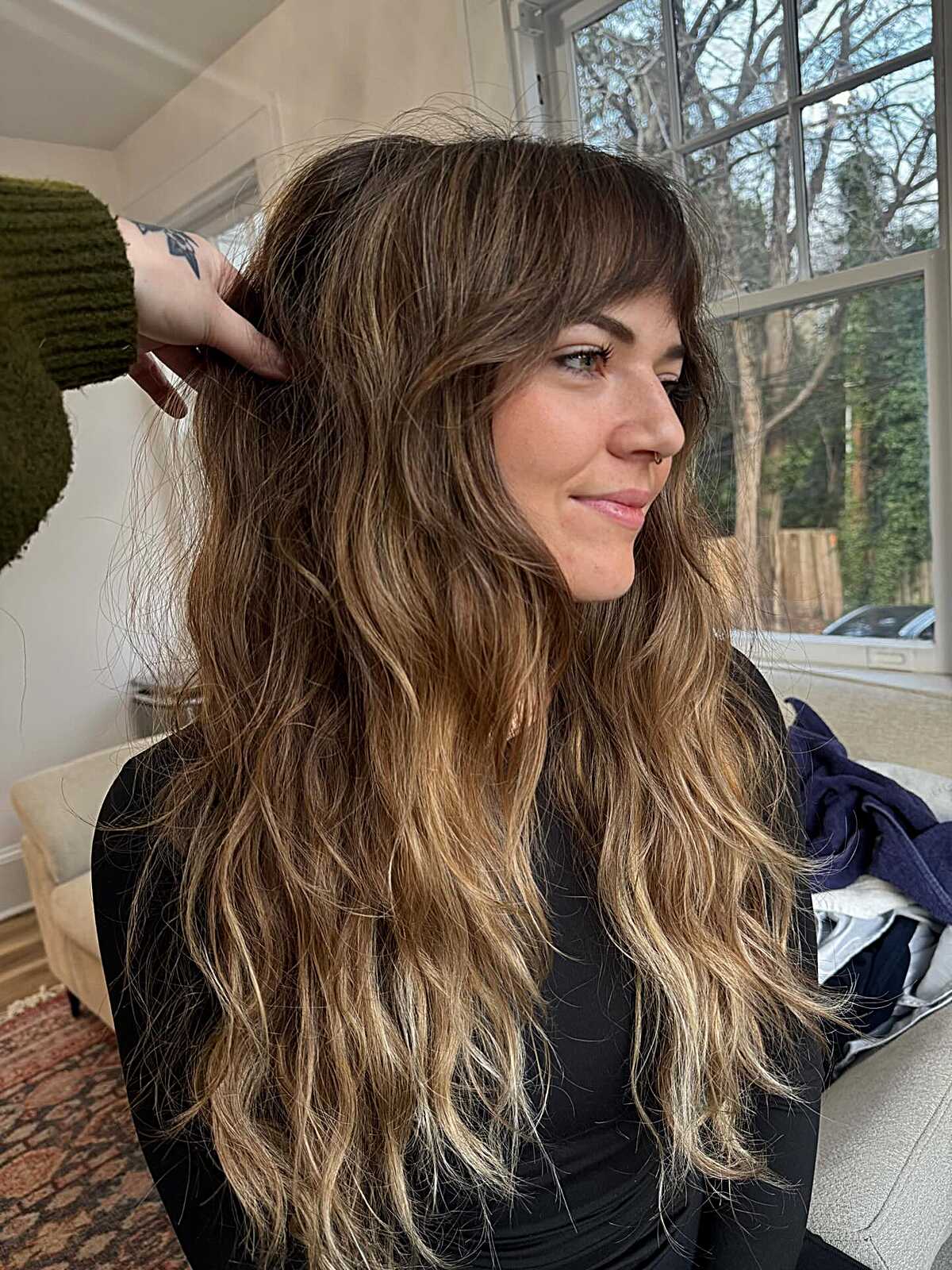 Long shaggy wavy hair with fringe and dimensional highlights.
