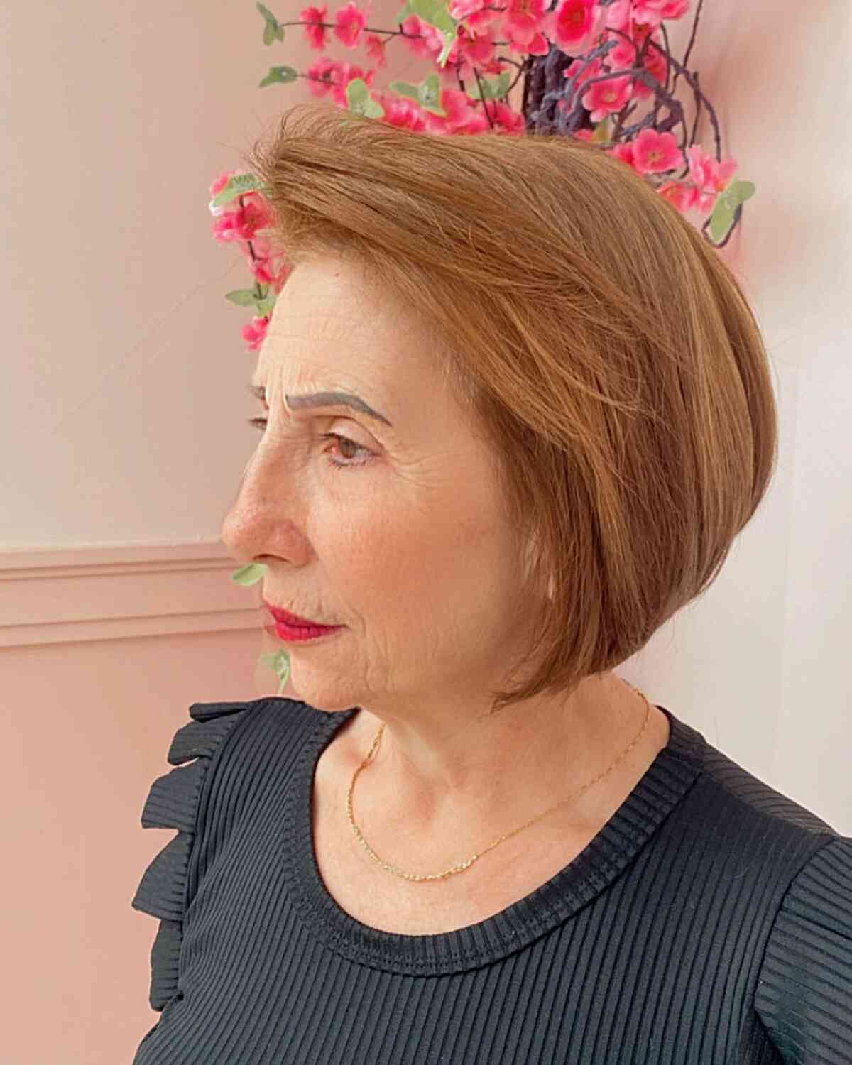 Smooth short bob with a side-swept top and close nape.