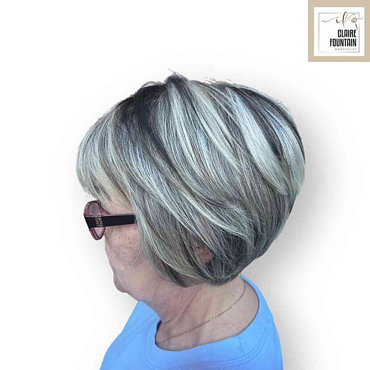 Graduated bixie with silver layers, lifted crown, and dark lowlights.