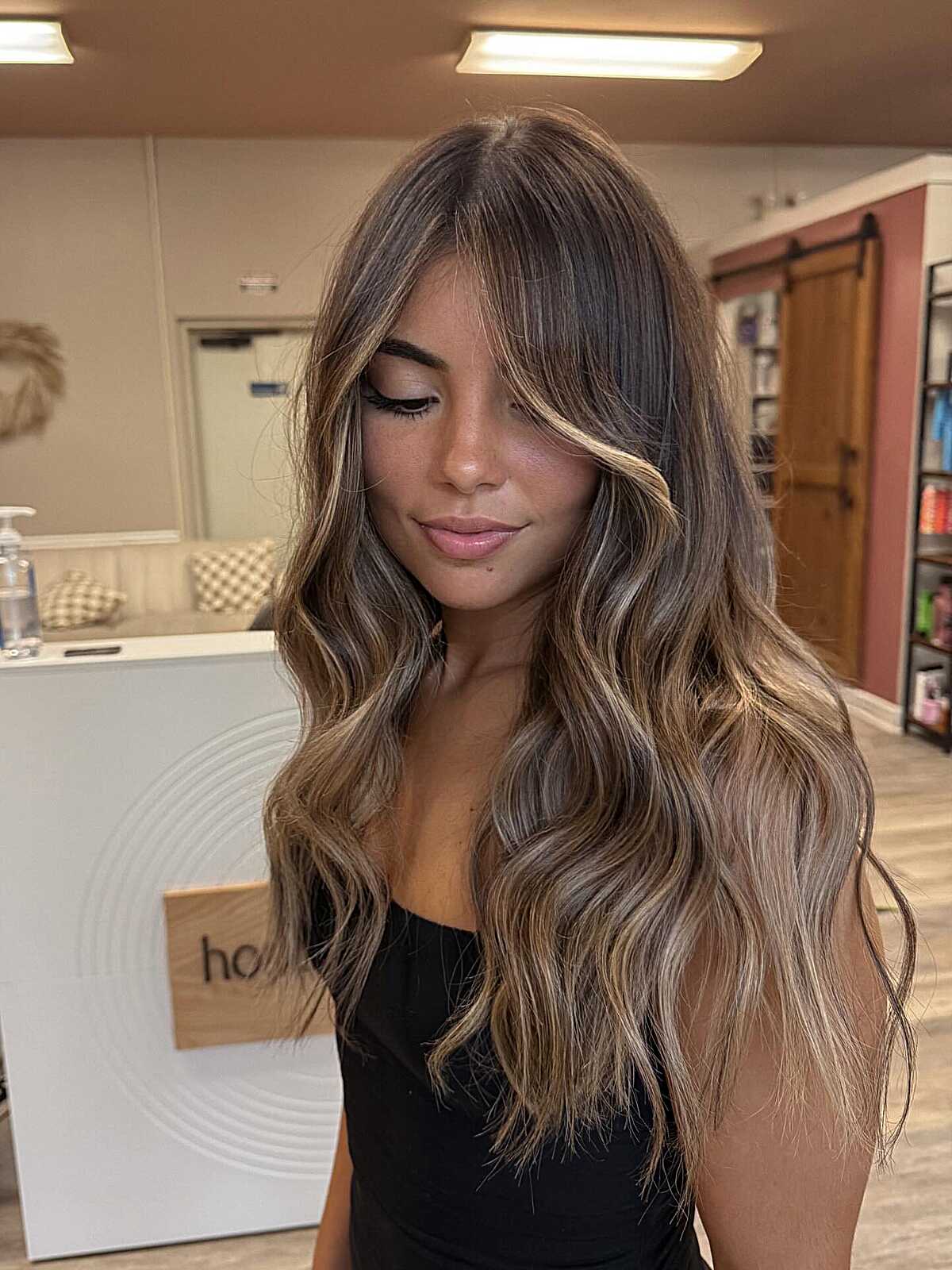 Long bronde waves with curtain bangs and light front pieces.