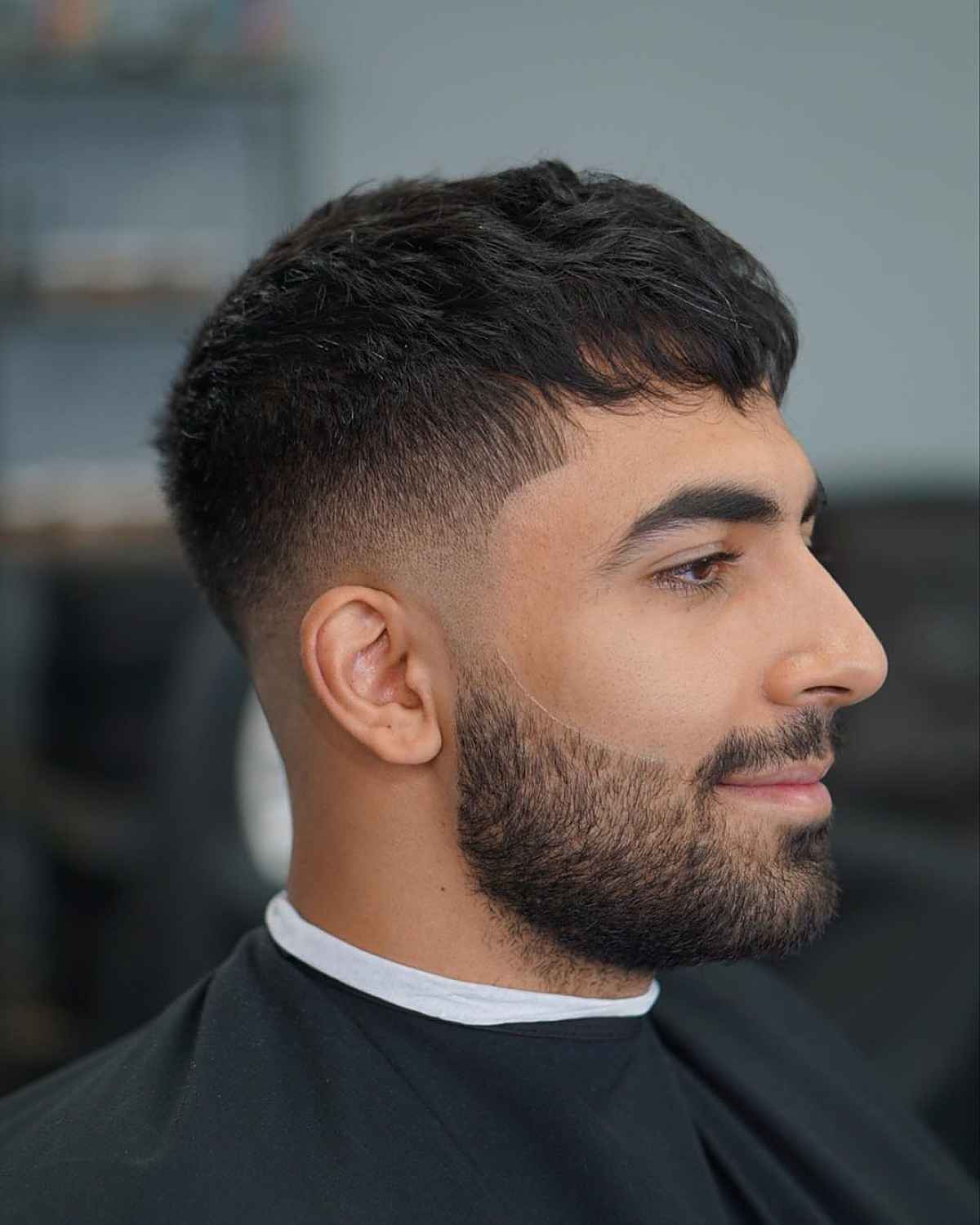 Forward fringe with a taper fade and textured dark top.