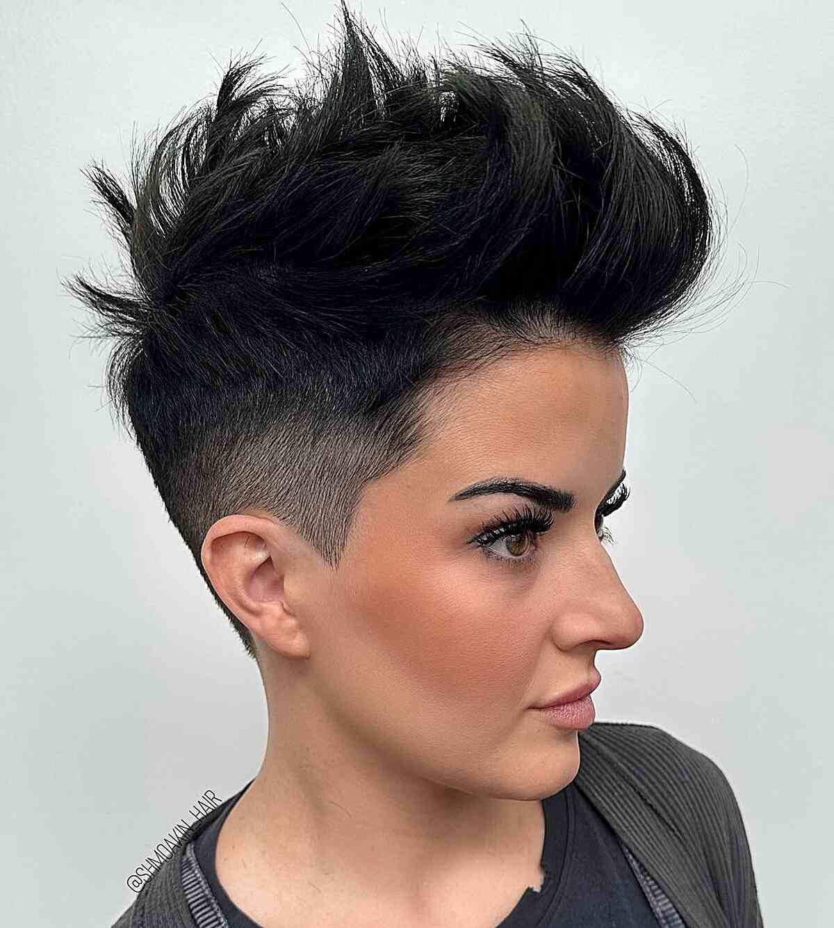 Black pixie with fade sides and tall spiky top.
