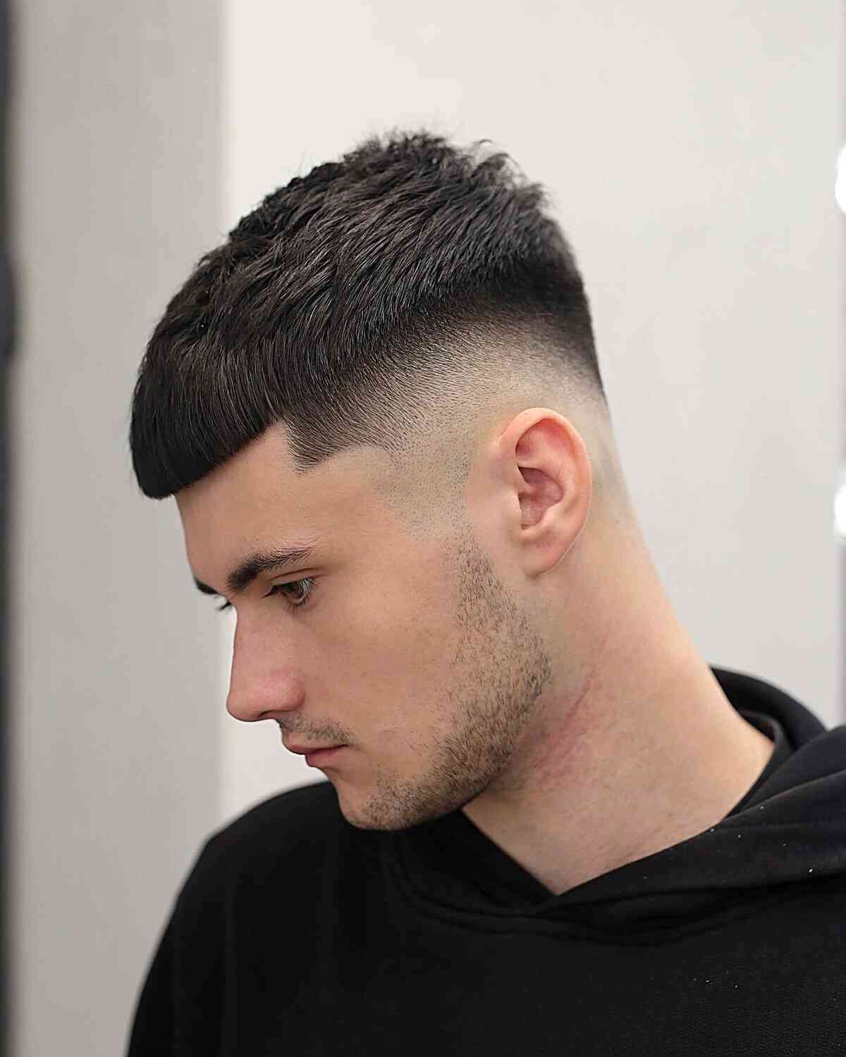 Short cropped fringe with a high skin fade on the sides.
