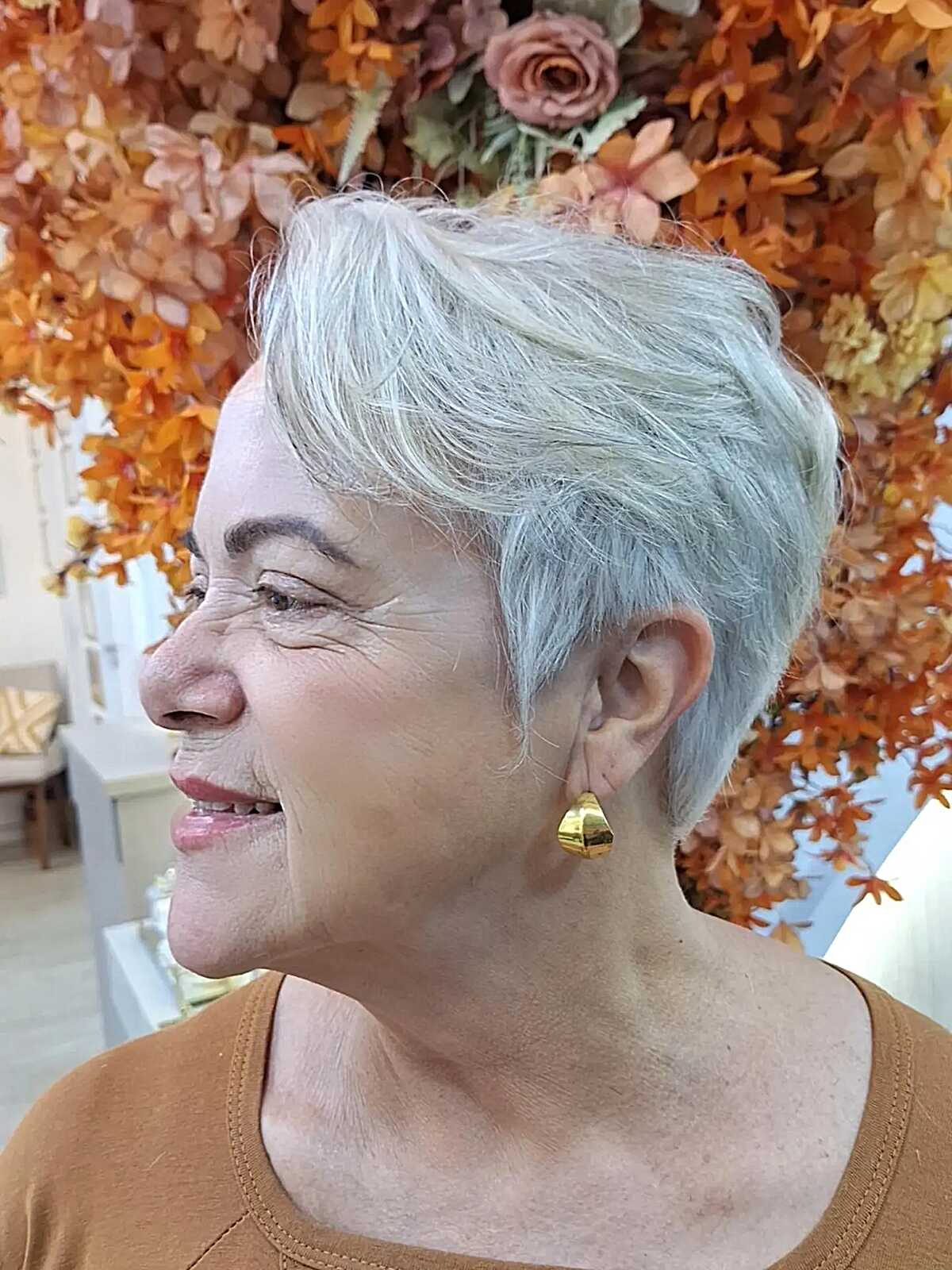 Silver pixie with swept-back crown volume and short sides.