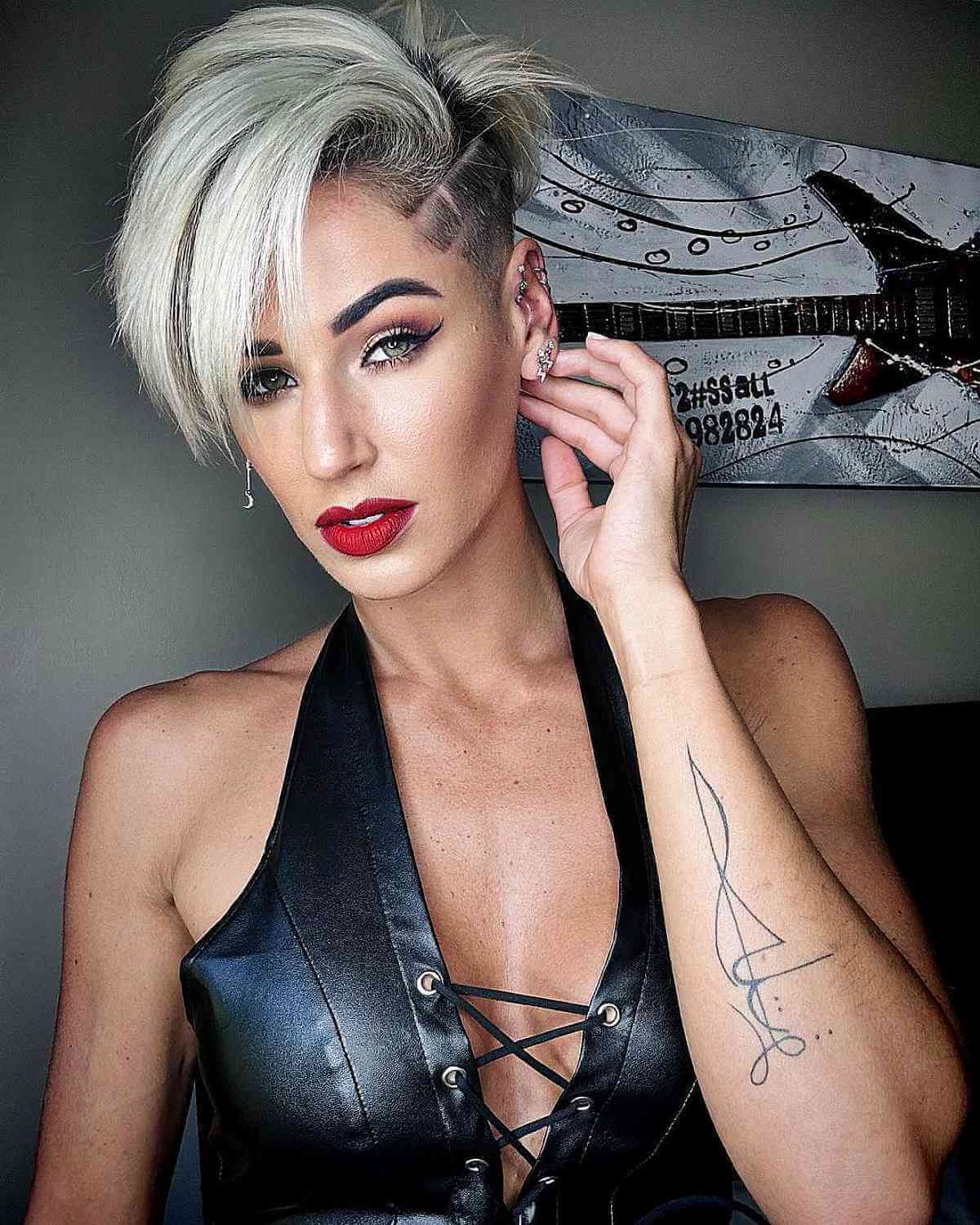 Platinum pixie with side shave, long fringe, and lifted crown.
