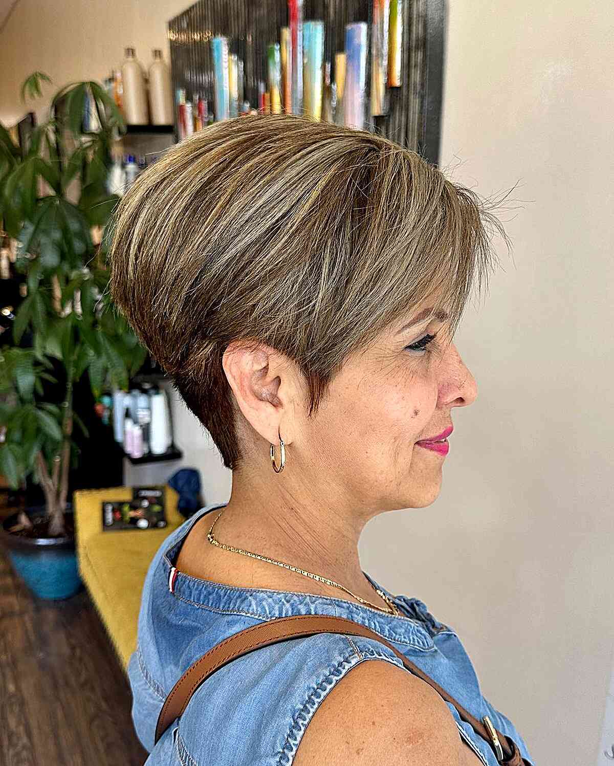 Short pixie bob with caramel highlights and a side-swept front.